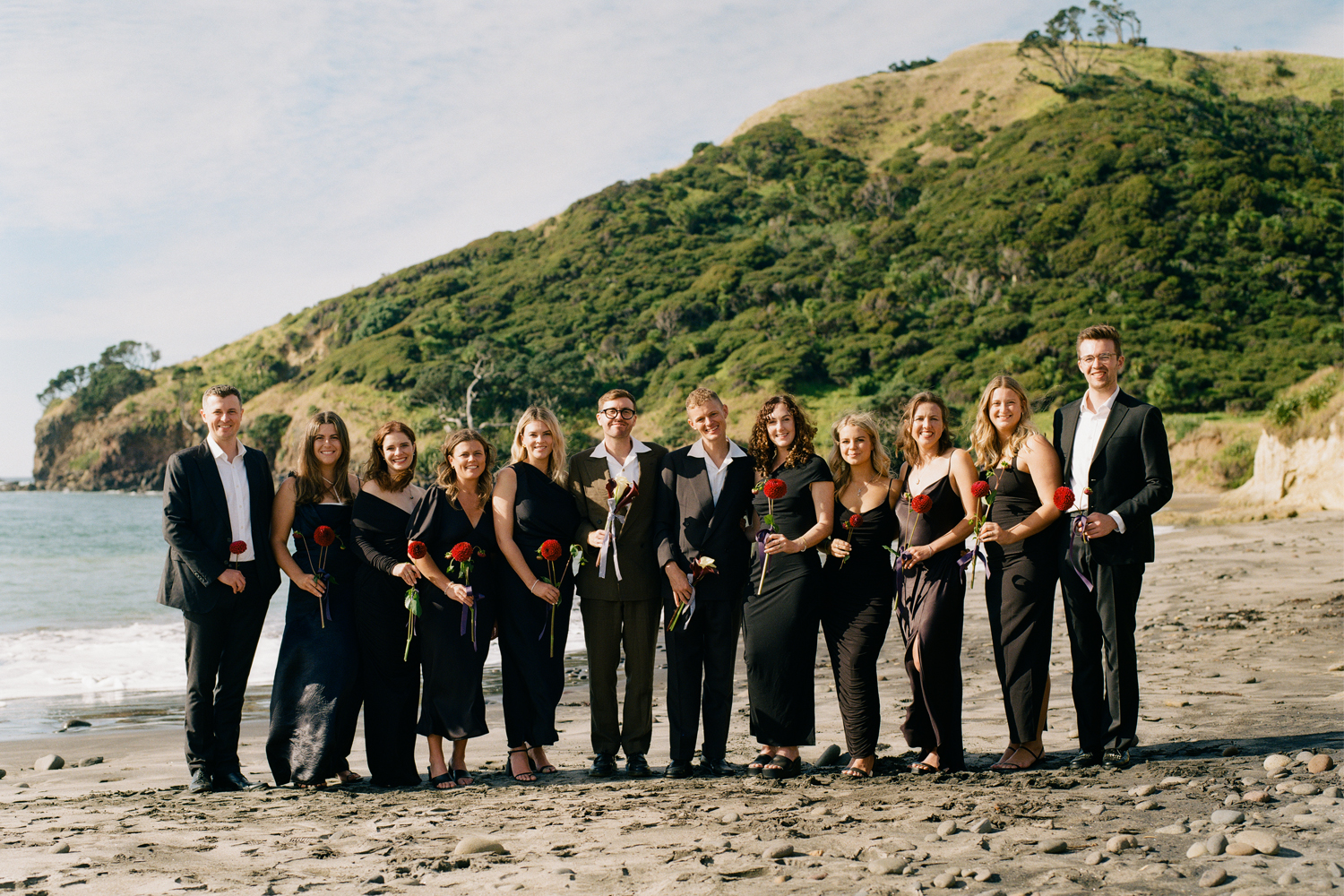 The bridesmaids and groomsmen wore black and selected their own dresses and suits. Photo / Poet Pictures