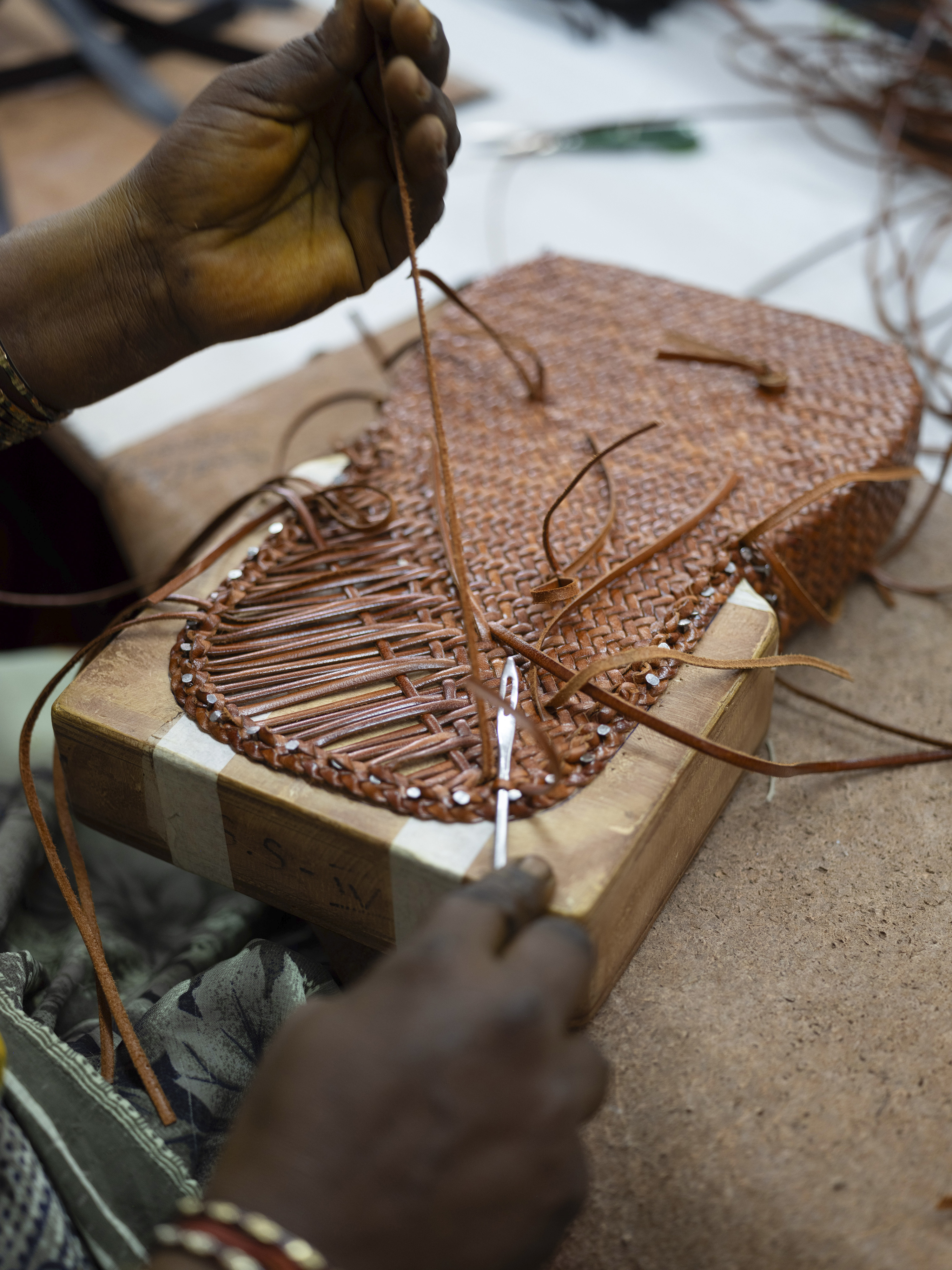 A weaver at work on a Dragon Diffusion Mini City Bag. Photo / Priyadarshini Ravichandran, The New York Times