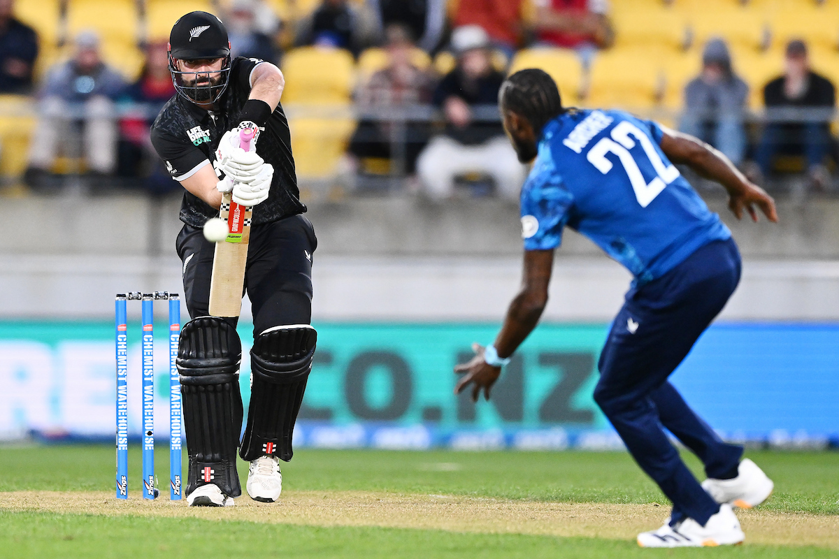 Daryl Mitchell defends against England's Jofra Archer. Photo / Photosport