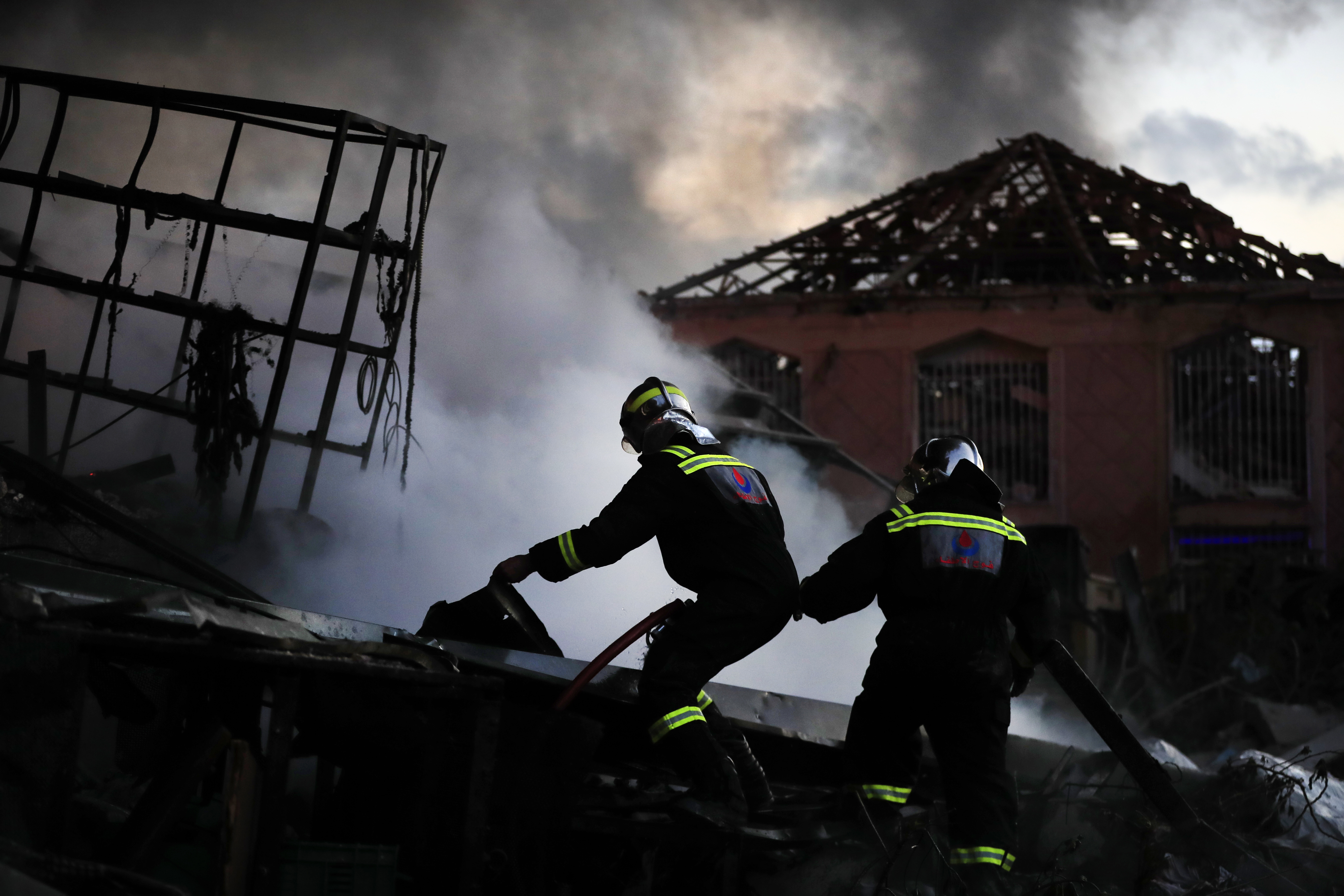 Firefighters in Ghazieh, Lebanon, extinguish a blaze at a warehouse that was destroyed during an Israeli airstrike.  Photo / AP 