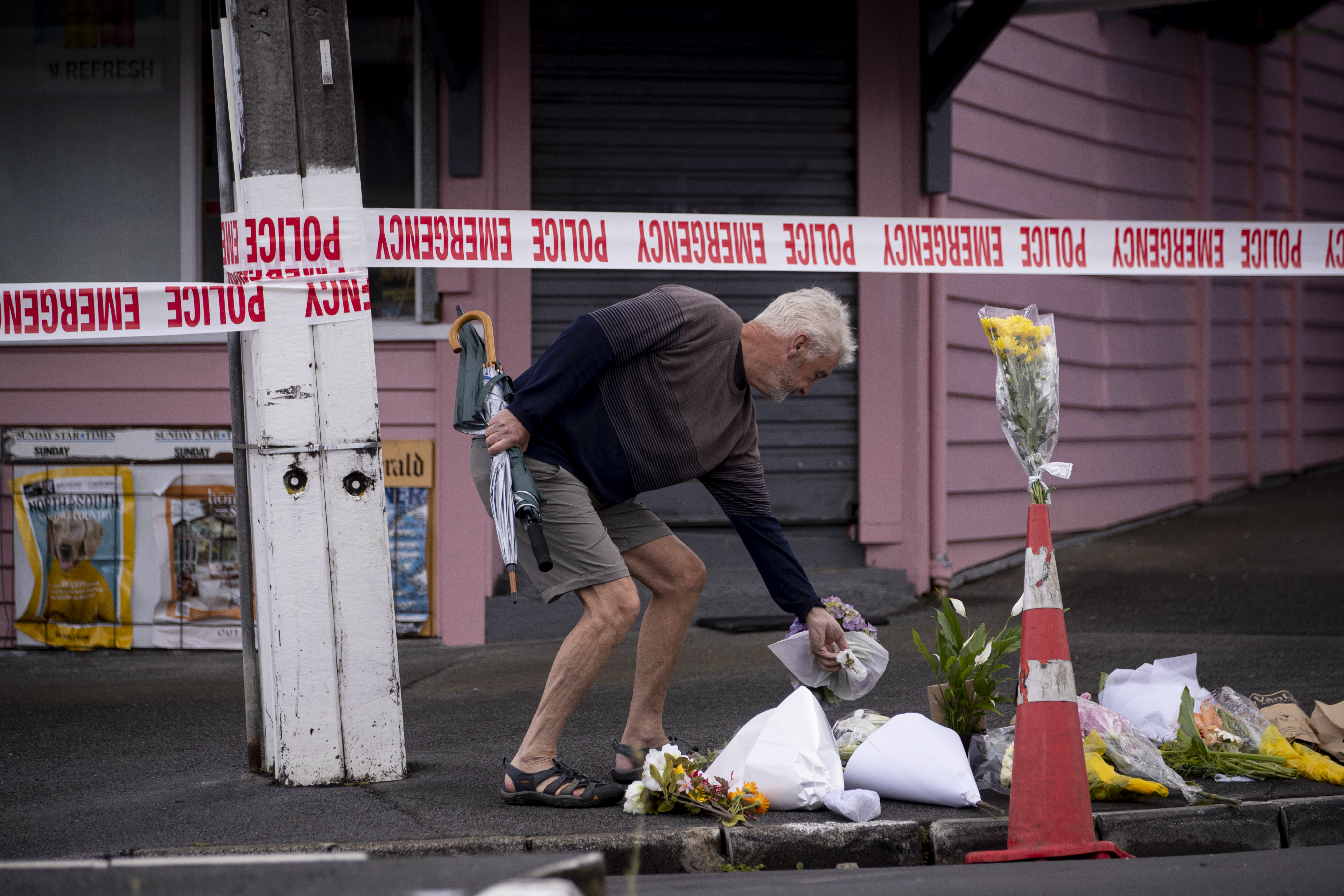 People gathered outside the Rose Cottage Superette in Sandringham to pay tribute to the slain worker. Photo / Dean Purcell