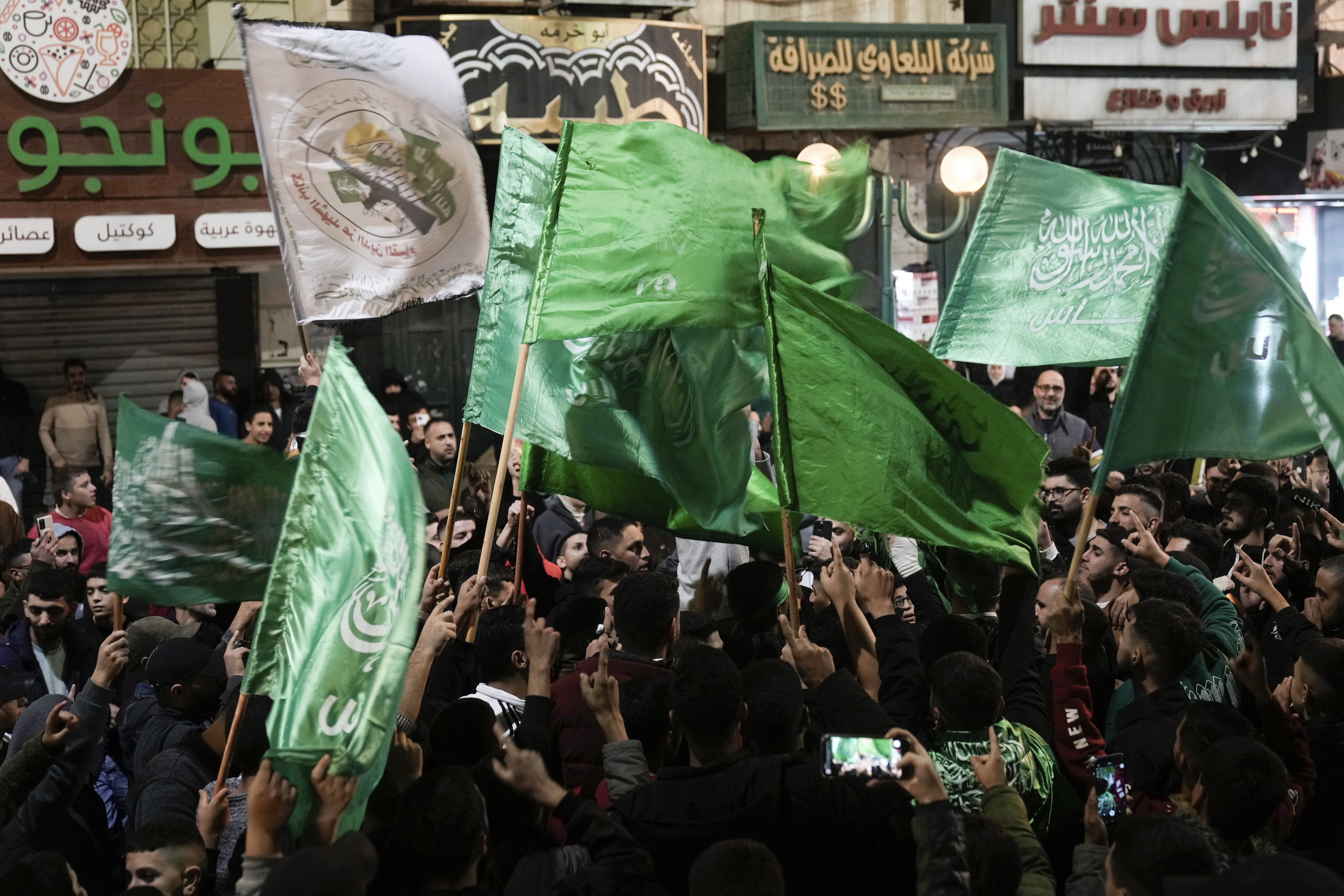 Palestinians wave Hamas flags as they celebrate the Israeli release of Palestinian prisoners in the West Bank city of Nablus, Photo / AP