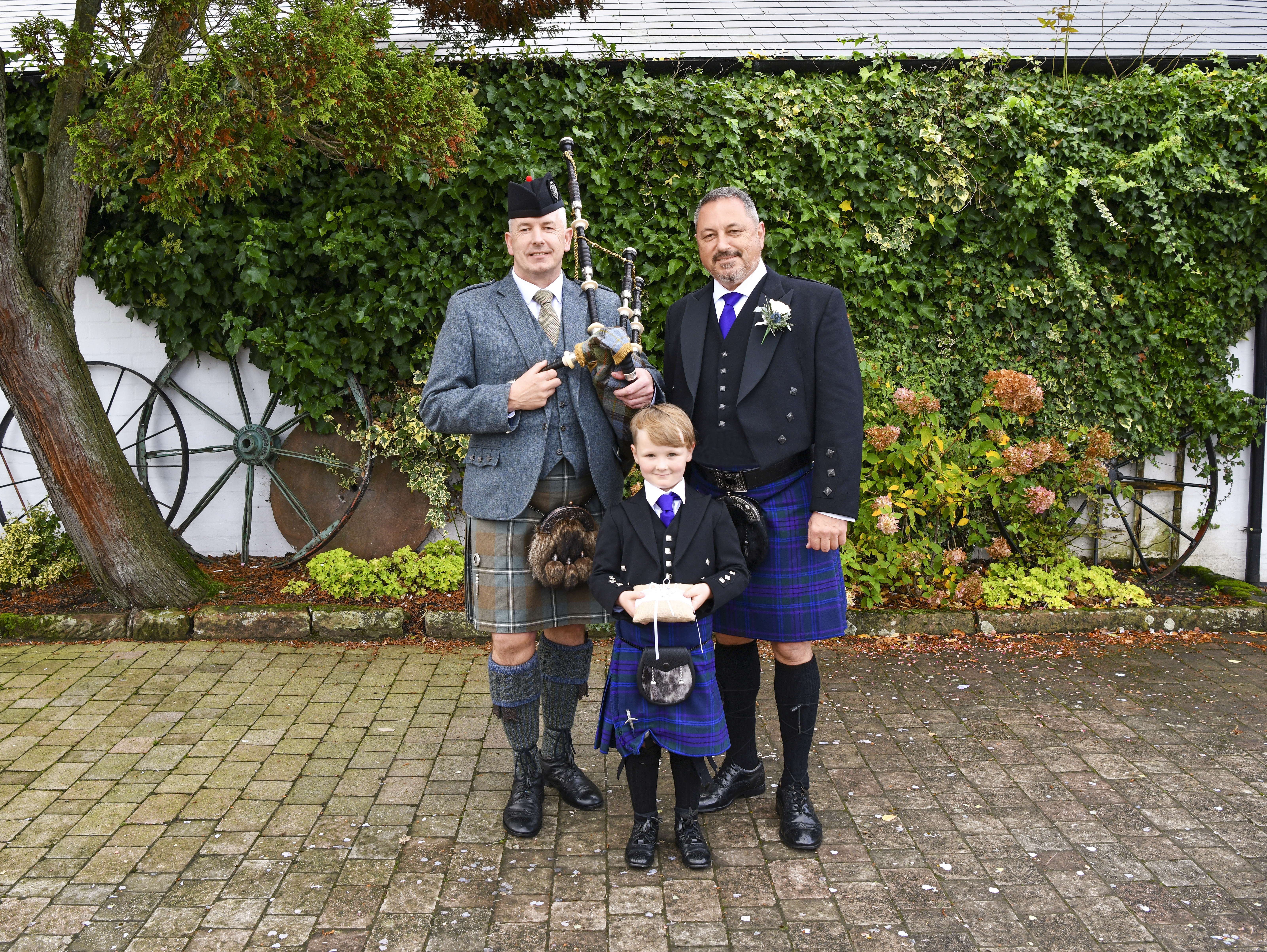 Patrick with the piper and Suzanne's godson Cillian. Photo / Supplied.