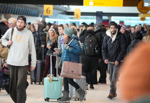 The storm sweeping the US has caused chaos for travellers, here, queueing to check in at the Southwest Airlines counter in Denver International Airport. Photo / AP
