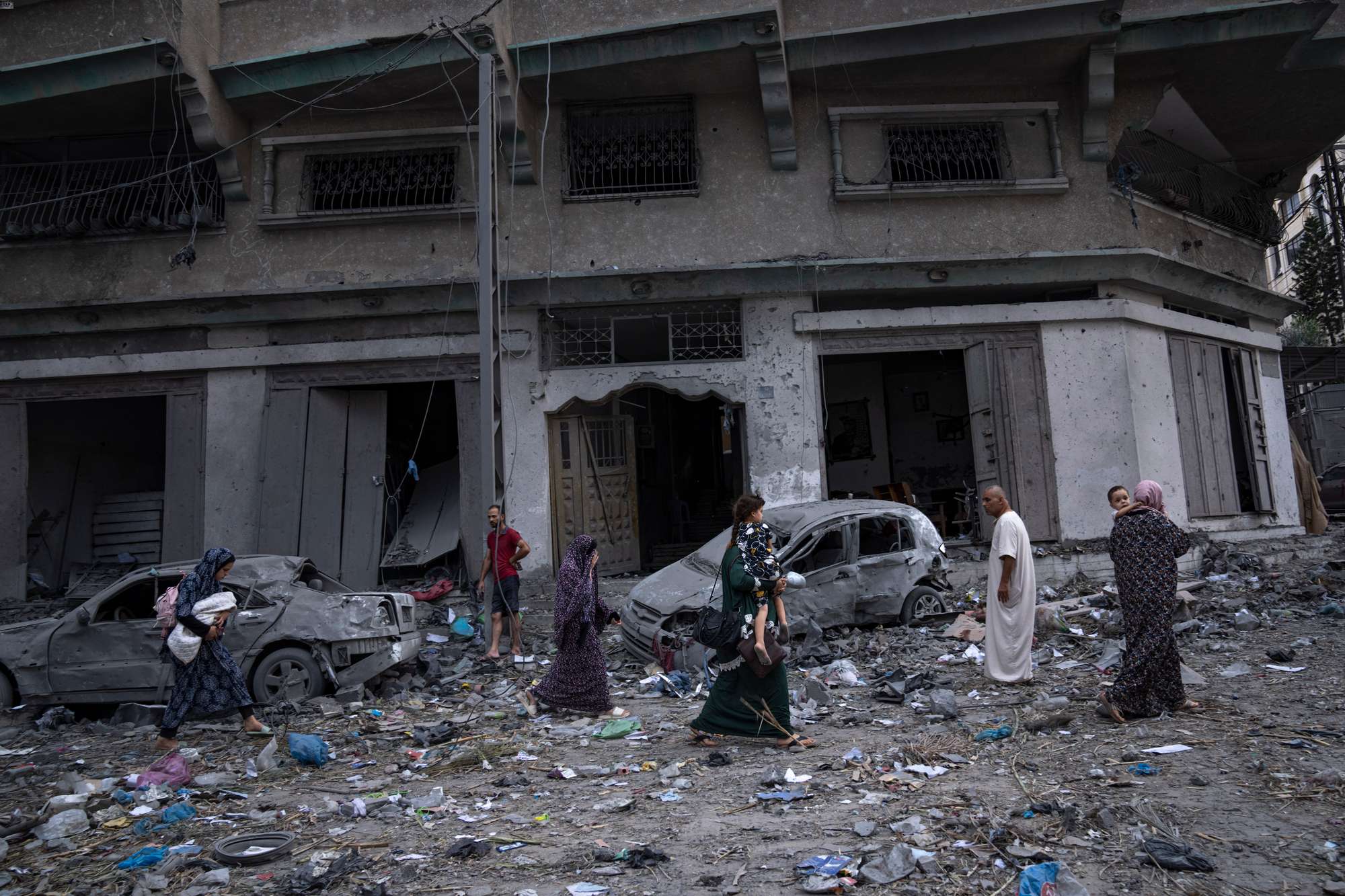 Palestinians walk amid the rubble following Israeli airstrikes that razed swaths of a neighbourhood in Gaza City. Photo / AP