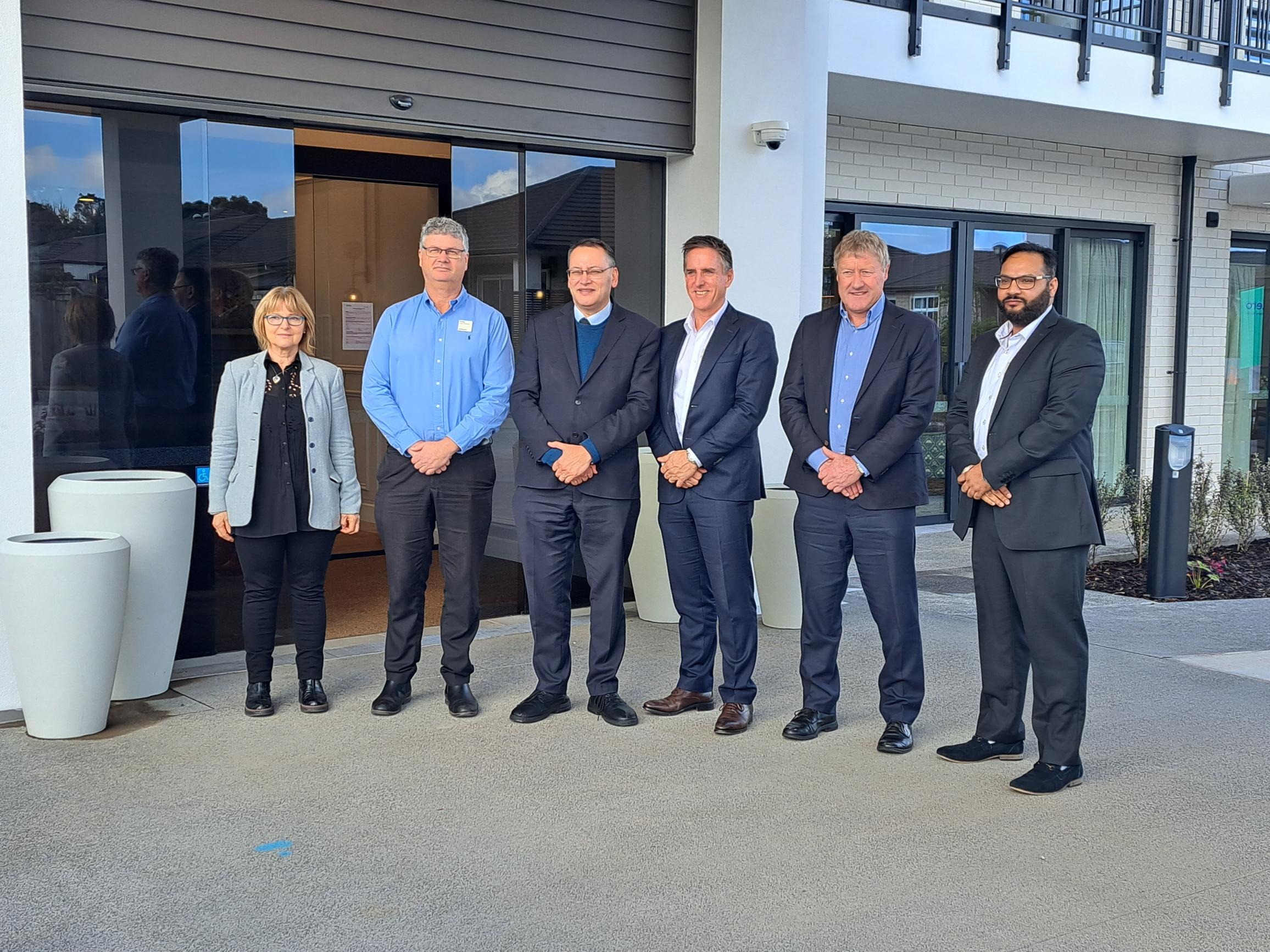 Metlifecare staff, including chief executive Earl Gasparich (centre), with Health Minister Shane Reti and Northland MP Grant McCallum at Oakridge Villas Care Home. Photo / Jenny Ling