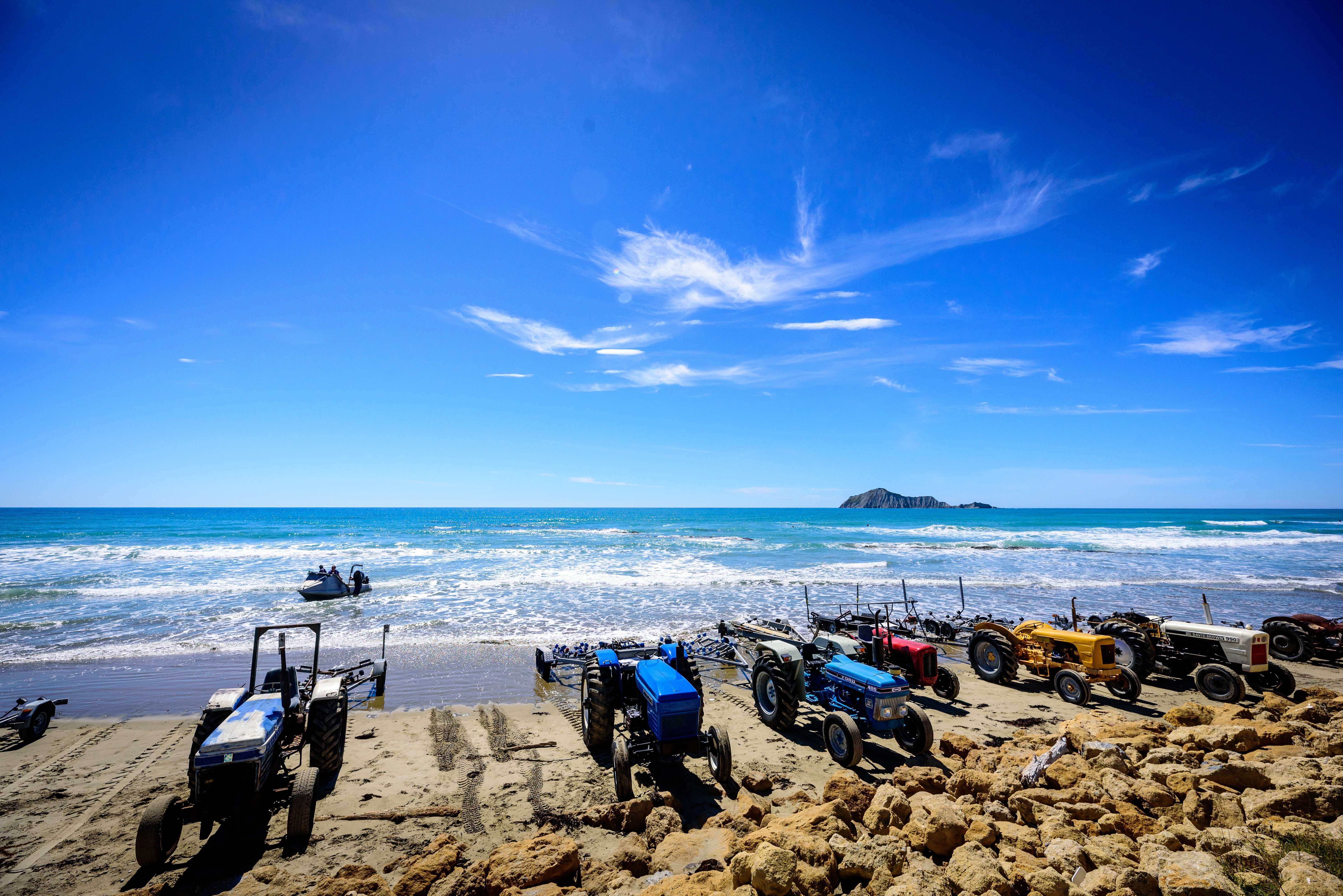 Using tractors to launch boats is a part of summer at Waimarama Beach.