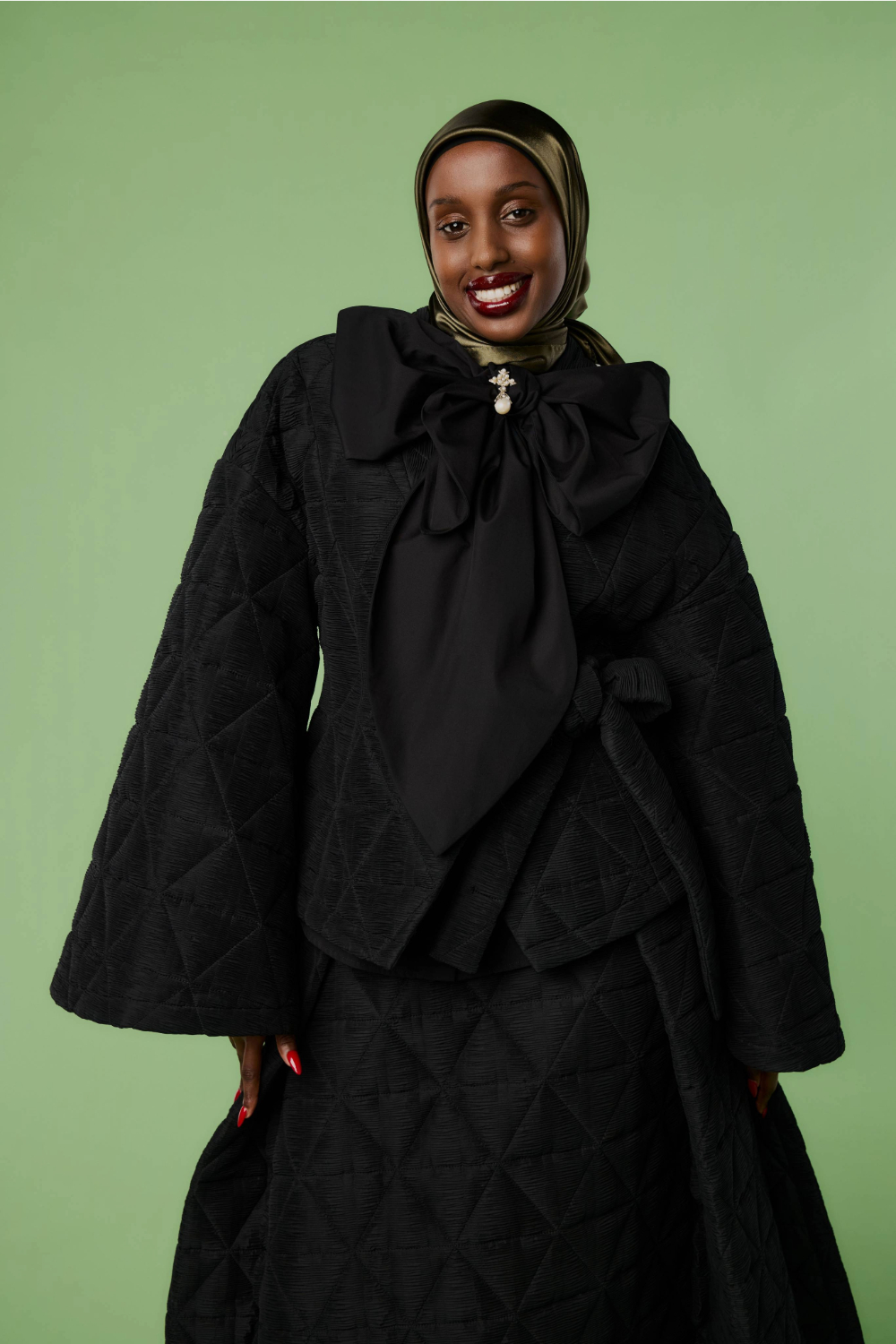 Yasmine Mohamud wears Claudia L skirt set, brooch by Niicolé Polard and shoes by Kathryn Wilson. Photo / Mara Sommer for New Zealand Fashion Week.