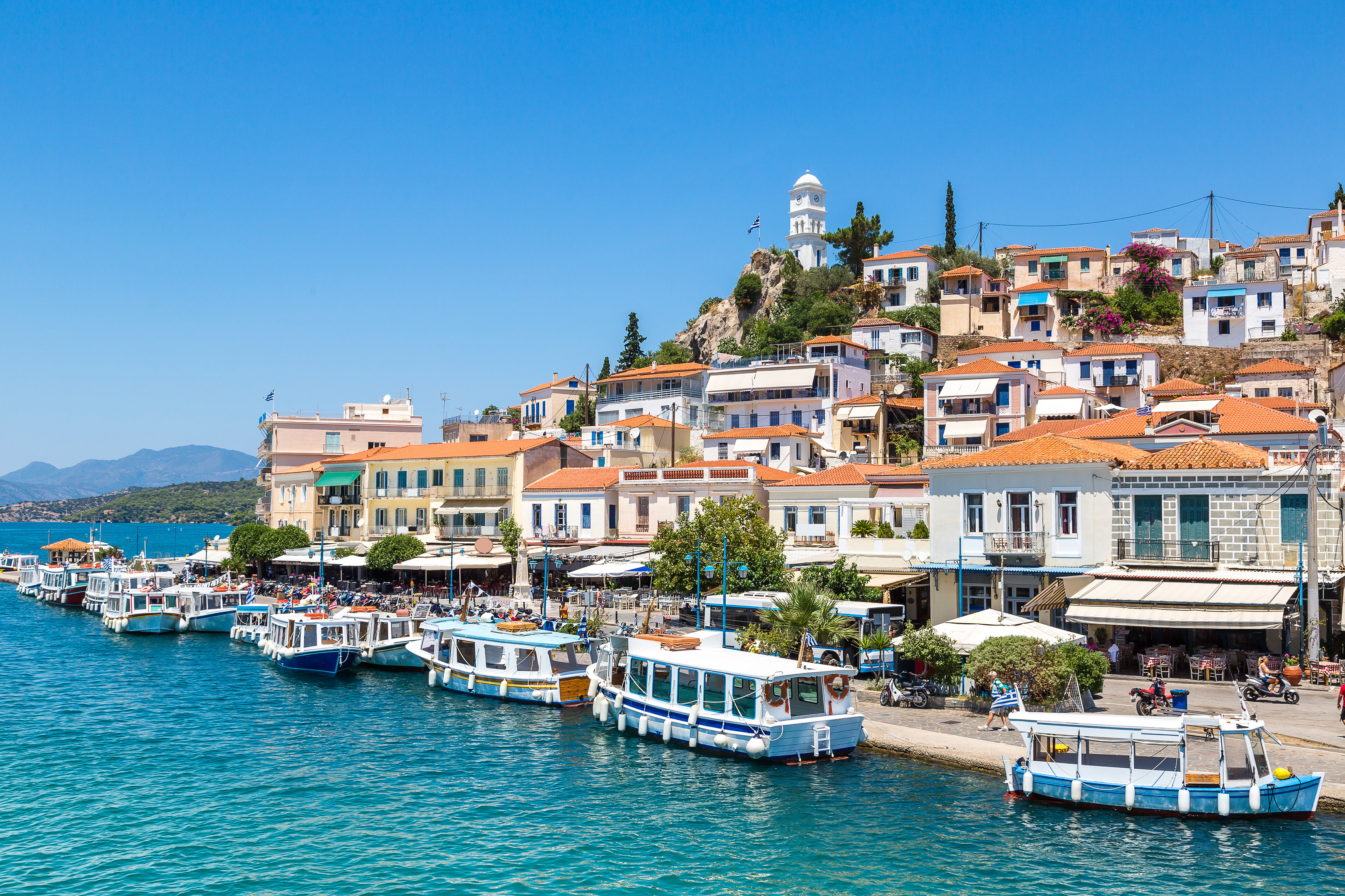 Poros, located near Athens, boasts two connected islands, great beaches for water sports, and cultural attractions like Zoodochos Pigi Monastery. Photo / 123rf