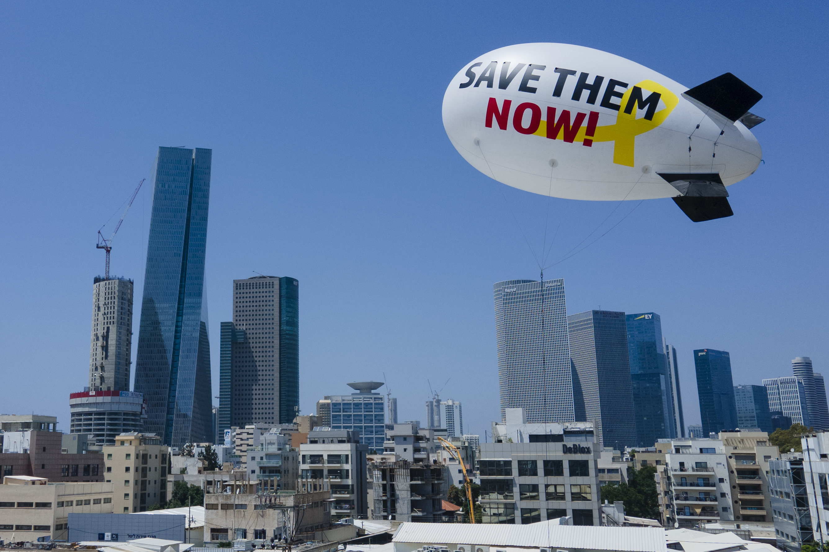 Family and friends of the remaining hostages held in the Gaza Strip by the Hamas militant group launch a small blimp calling for their release in Tel Aviv, Israel. Photo / AP