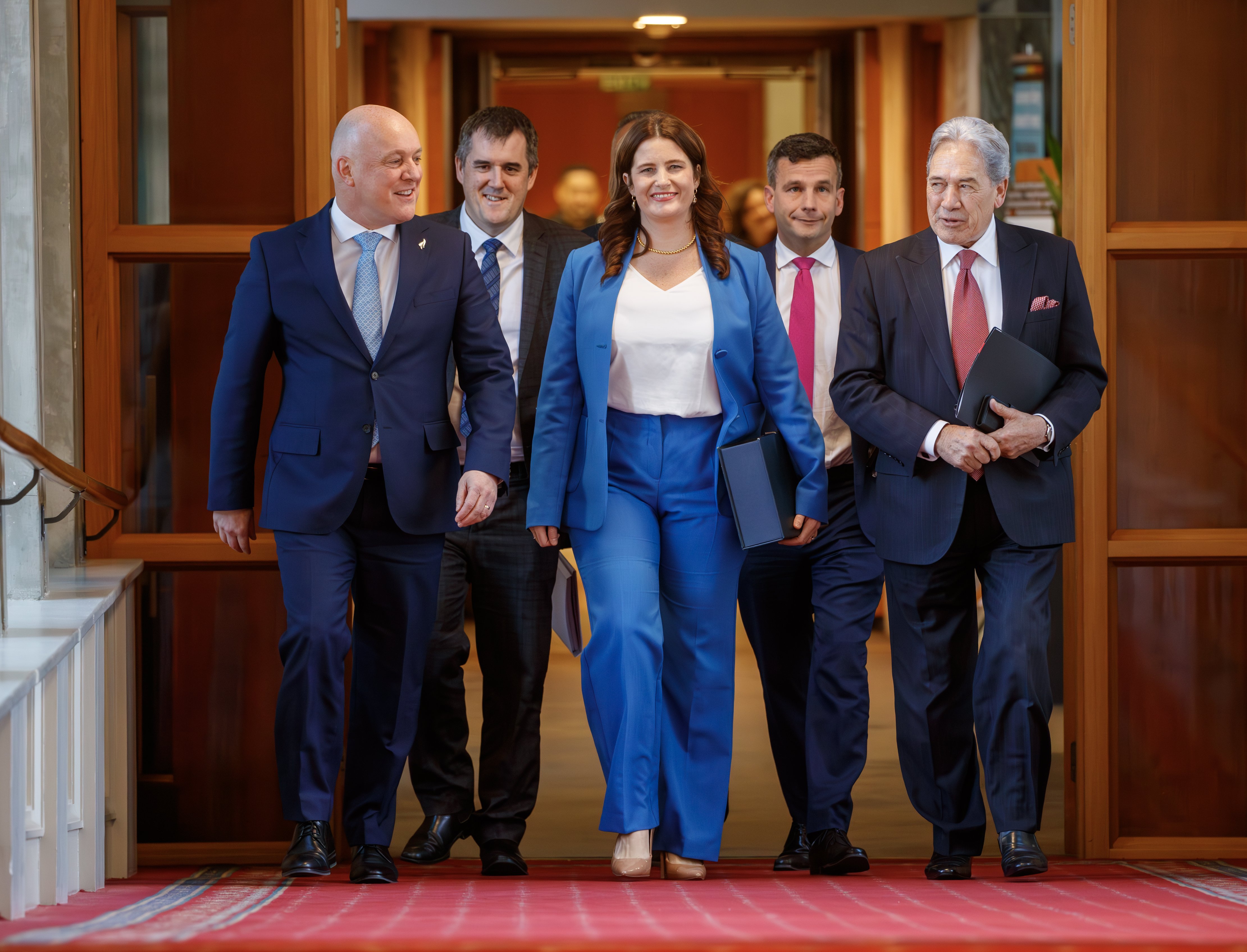 Finance Minister Nicola Willis with, from left, Christopher Luxon, Chris Bishop, Shane Jones, David Seymour and Winston Peters, on the way to the House for the reading of Budget 2024, which hit 'pause' on the rollout of Te Ao Marama pending a review. Photo / Mark Mitchell 