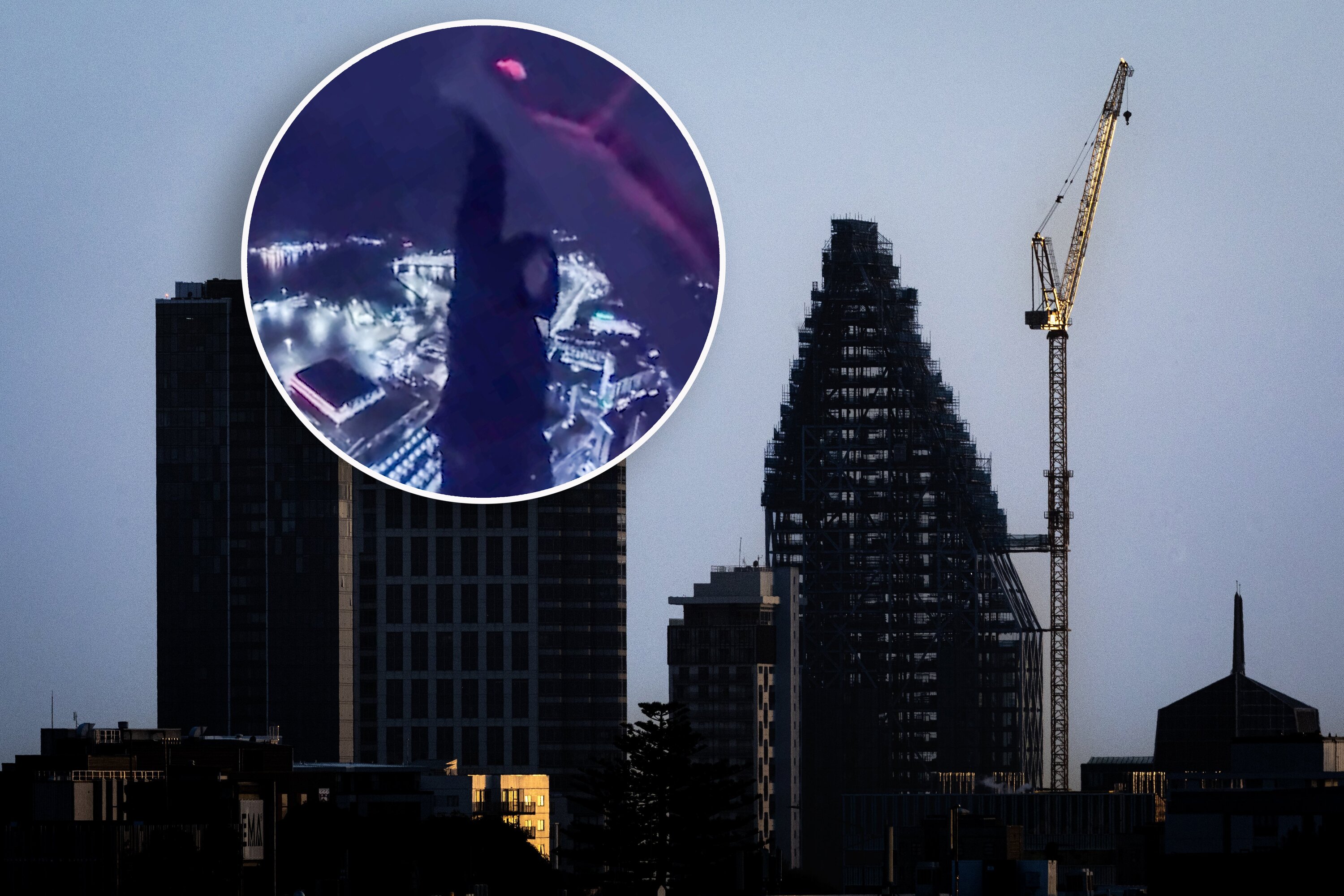 Seascape, a residential skyscraper under construction in the Auckland city centre, with the daredevil hanging by one hand. Composite photo / NZME