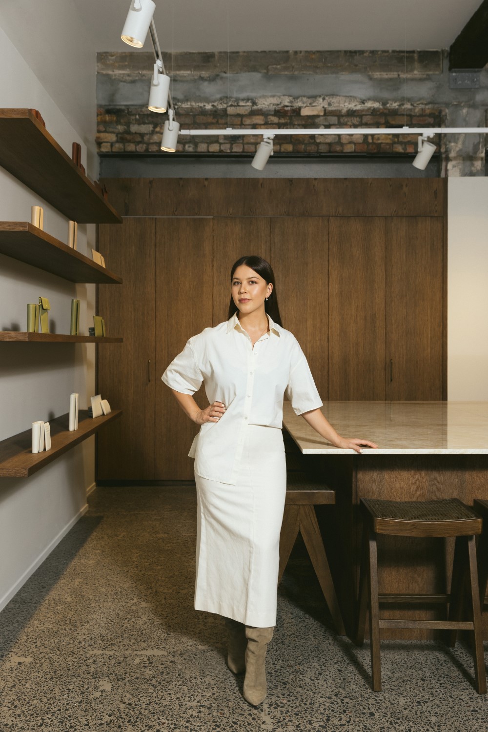 Yu Mei founder Jessie Wong at the Newmarket store. Jessie wears Jessica McCormack earrings from Simon James, The Row shirt, Yu Mei skirt, Margiela boots. Photo / Jono Parker 