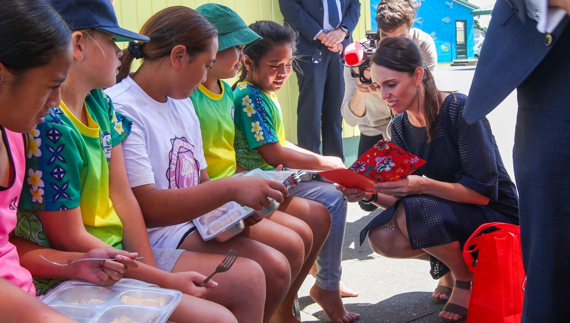 Jacinda Ardern shares a child's free school lunch at Flaxmere Primary School in Hawke's Bay in February. Free lunches will be expanded to 200,000 students by next year. Photo / Hawkes Bay Today 