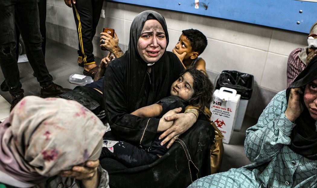 Palestinians wounded at Ahli Arab Hospital sit on the floor at al-Shifa Hospital. Photo / AP