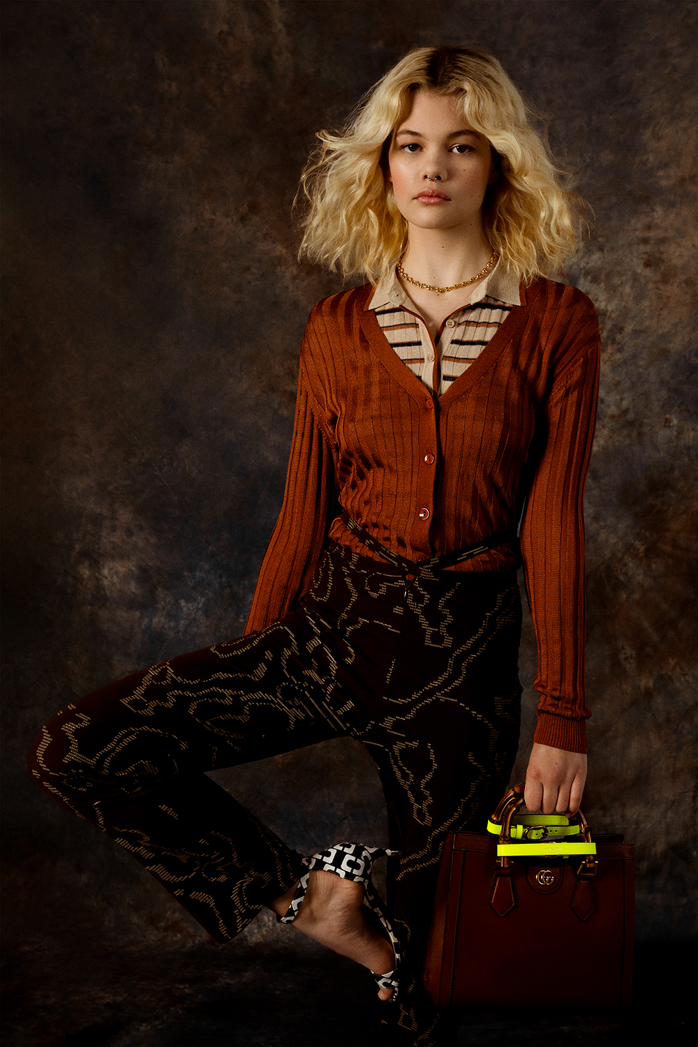 Rune wears a Kate Sylvester cardigan, Karen Walker top, Paloma Wool trousers, Meadowlark necklace, Gucci bag, and Kathryn Wilson shoes. Photo / Mia Vinaccia