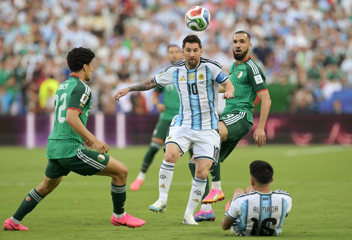 Argentina's Lionel Messi gestures in front of the ball alongside Algeria's Ibrahim Maza and Nabil Bentaleb during the 2026 World Cup Group J match. Photo / AFP