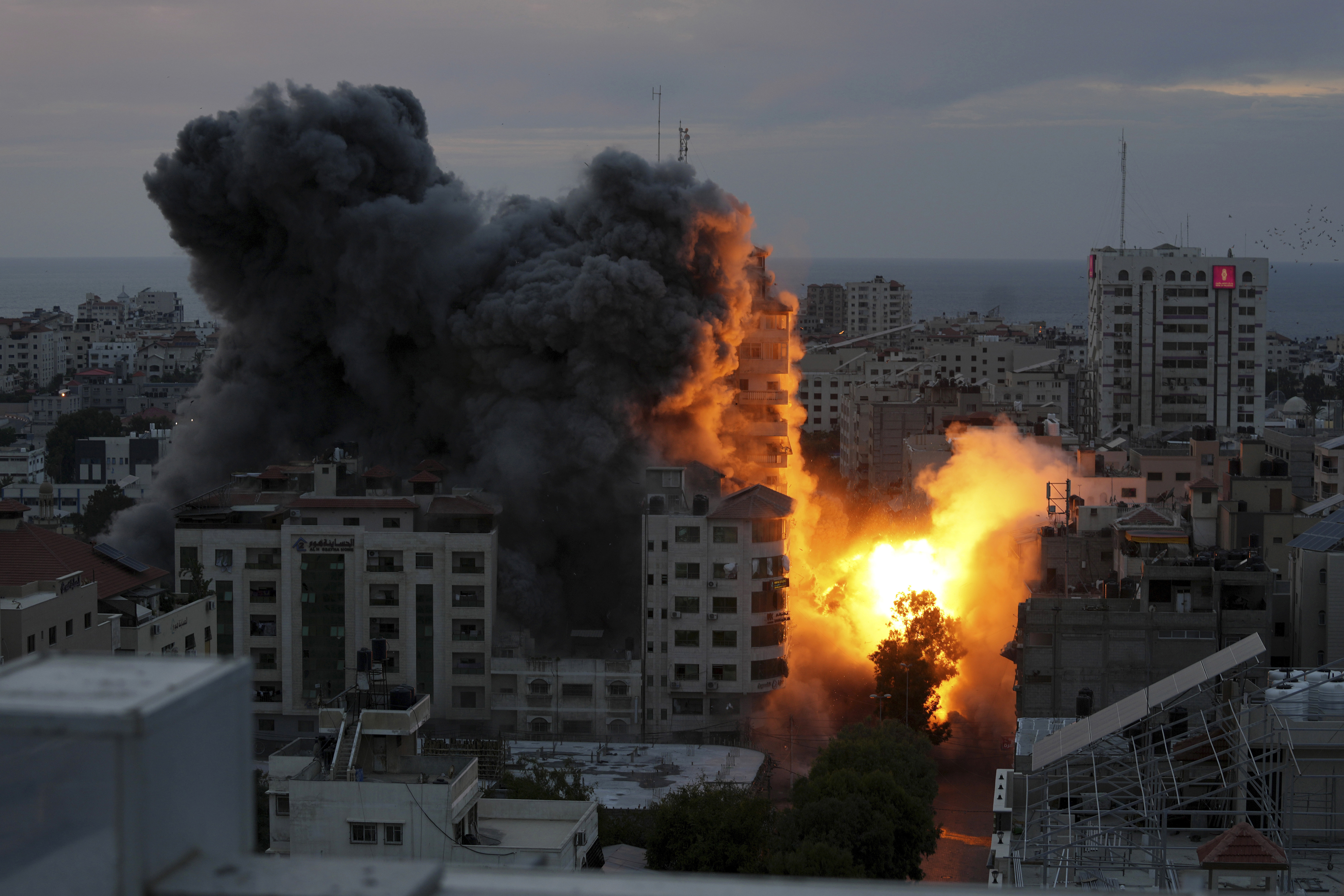 A ball of fire and smoke rises from an explosion on a Palestinian apartment tower following an Israeli air strike in Gaza City. Photo / AP