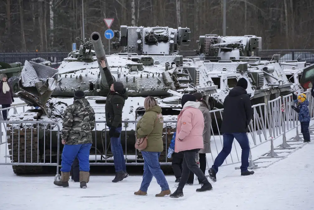 People visit an exhibition of tanks and APCs of Ukrainian armed forces damaged and captured during the fighting at an exhibition at the museum 