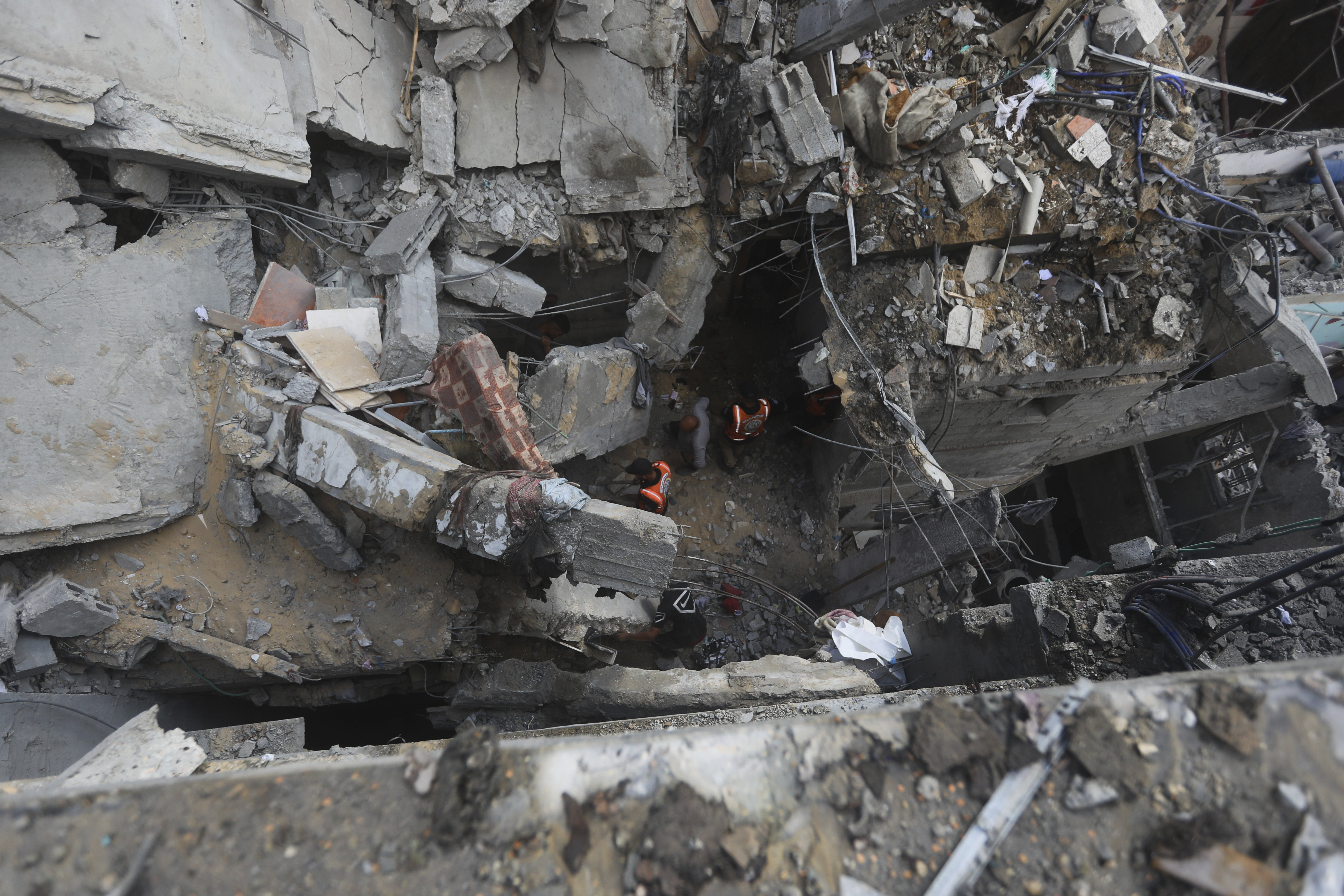 Palestinians look at the destruction after an Israeli strike on a residential building in Rafah, Gaza Strip. Photo / AP