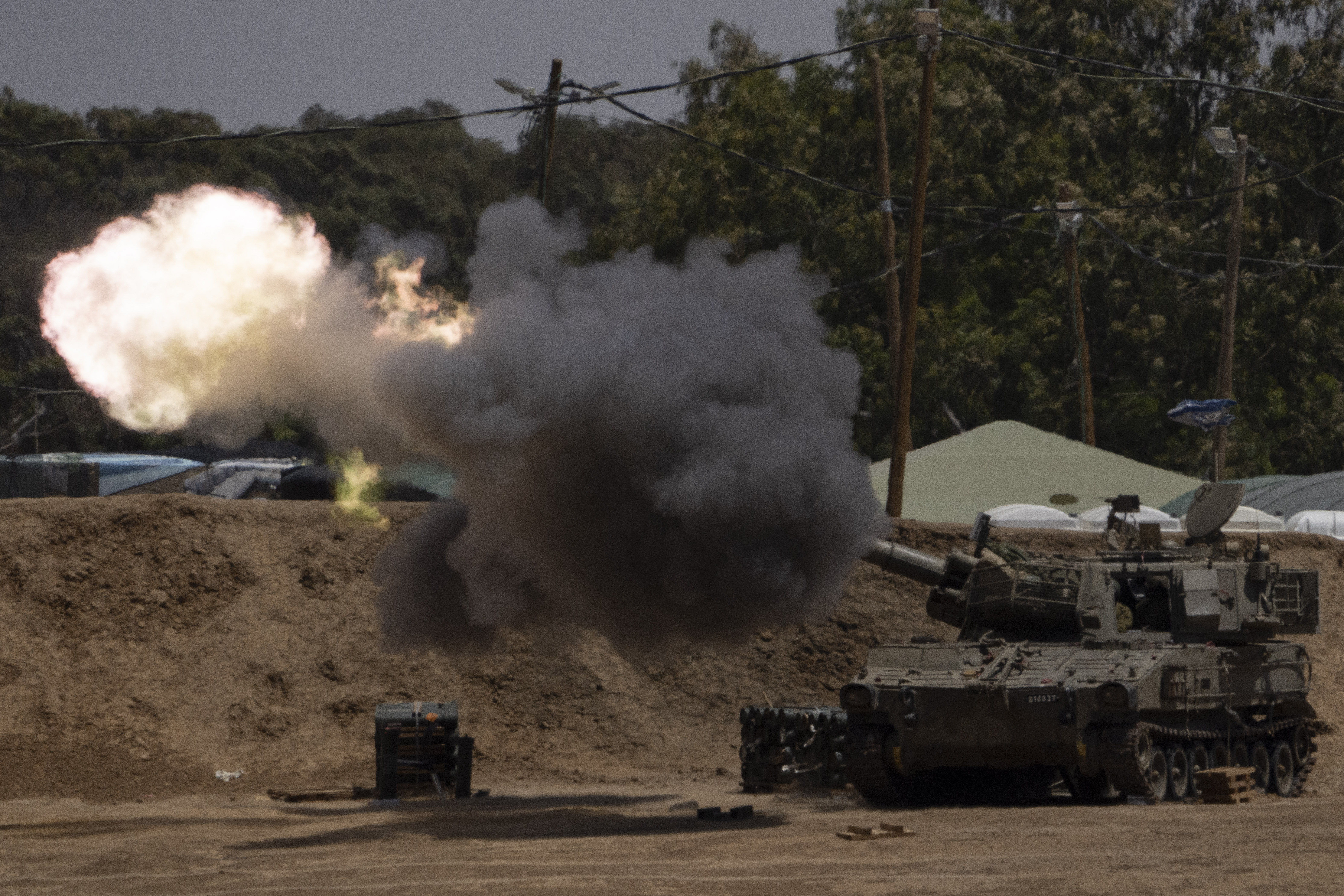 An Israeli mobile artillery unit fires a shell from southern Israel towards the Gaza Strip, in a position near the Israel-Palestine border. Photo / AP
