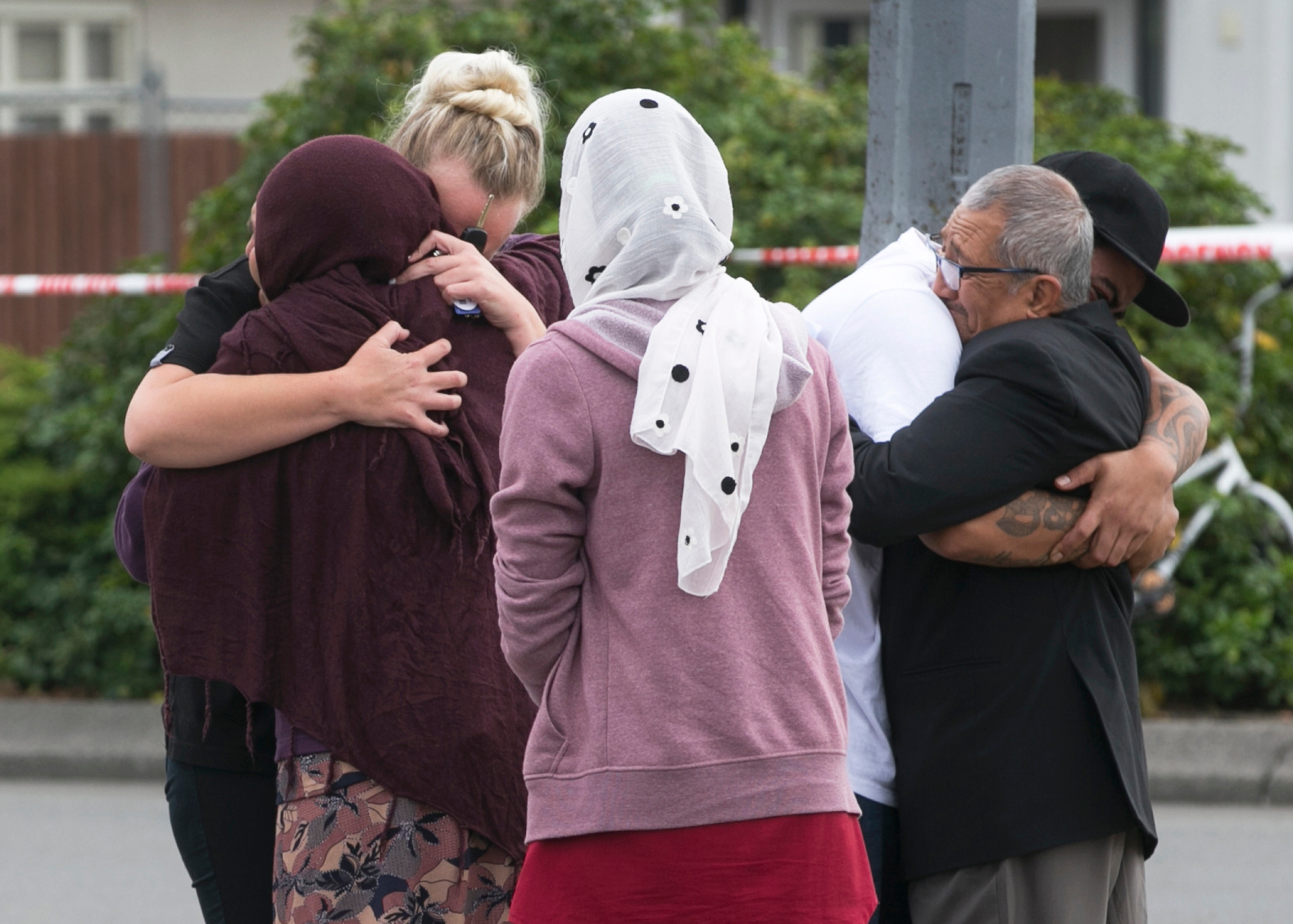 People share their grief at the police cordon outside the Linwood Ave Mosque in Christchurch. Photo / Alan Gibson