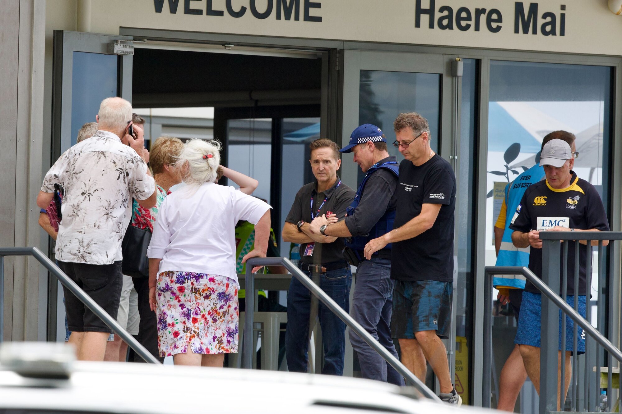 Campers speak to police at an emergency hub set up at the Mount Maunganui Surf Club on the day of the deadly landslide. Photo / Jason Dorday. 