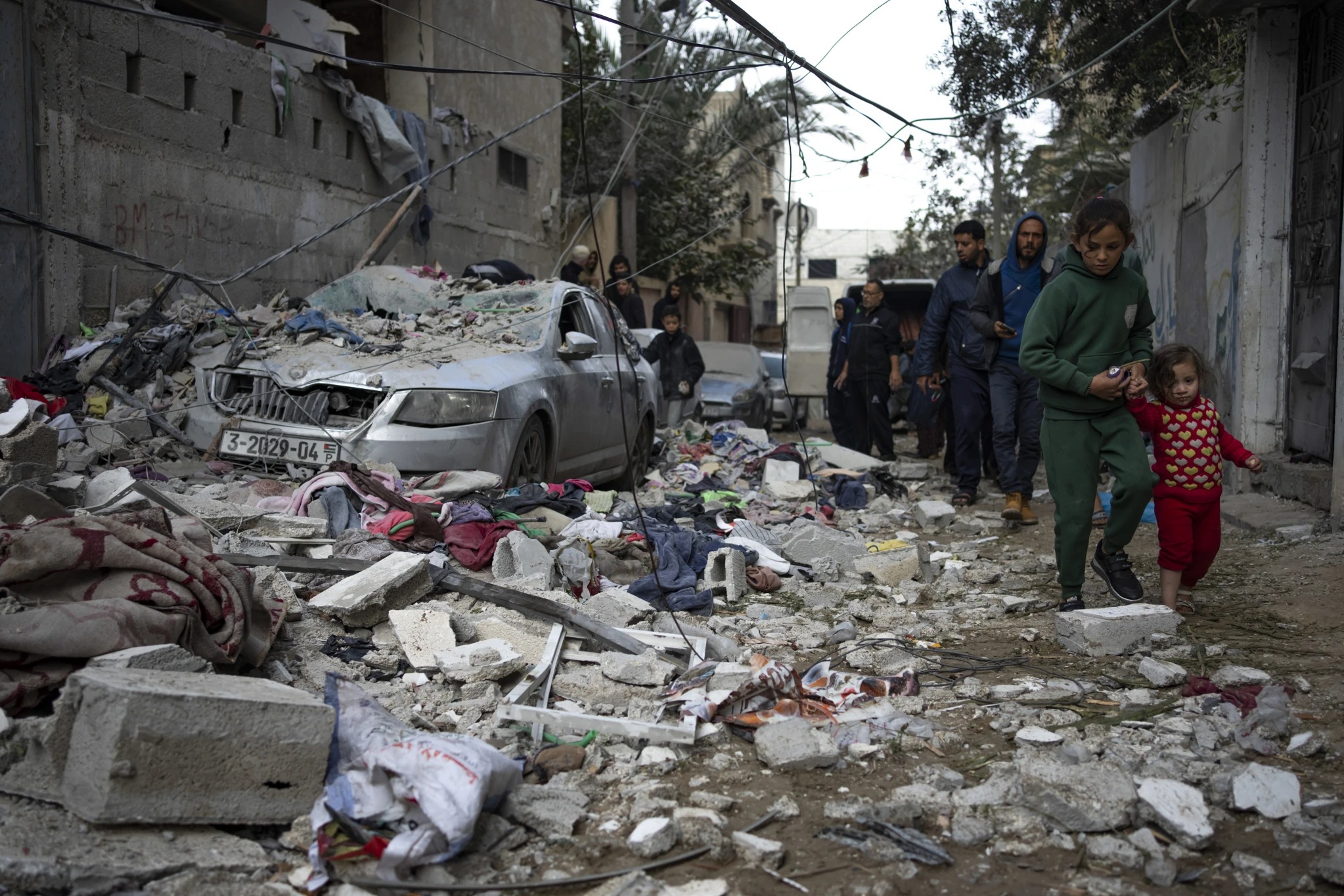 Palestinians look at the destruction after an Israeli airstrike in Rafah, Gaza Strip. Photo / AP