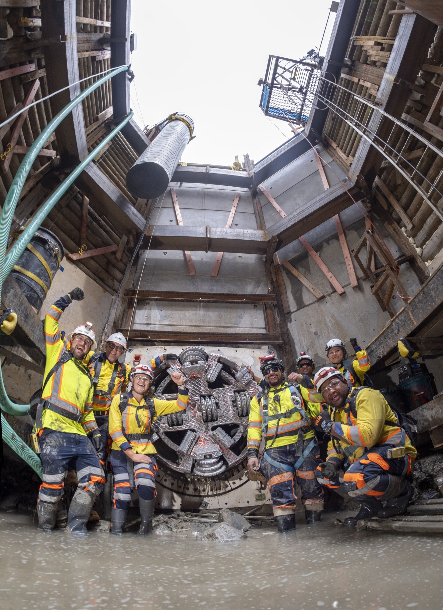 The Watercare team celebrate the micro tunnel boring machine breakthrough at Victoria St East.