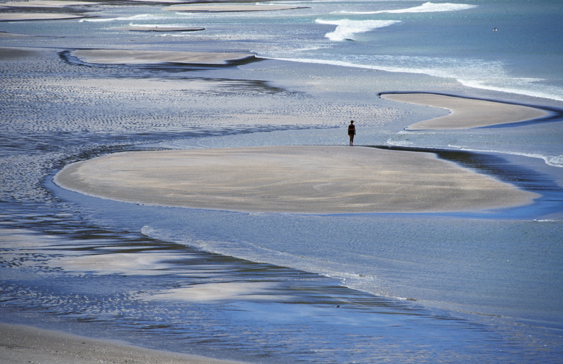 There’s a sprawling DoC campsite at Waikawau Bay, right next to the long, sandy surf beach. Photo / Getty Images