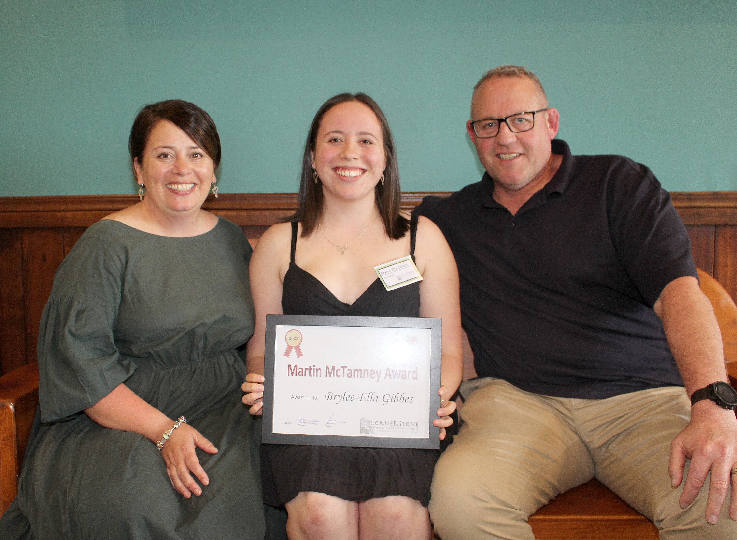 HipHop dancer Brylee Gibbes received the Martin McTamney Award this year. She is pictured with her parents Lanah and Chris on the All Blacks bench. Photo / Cathy Asplin 