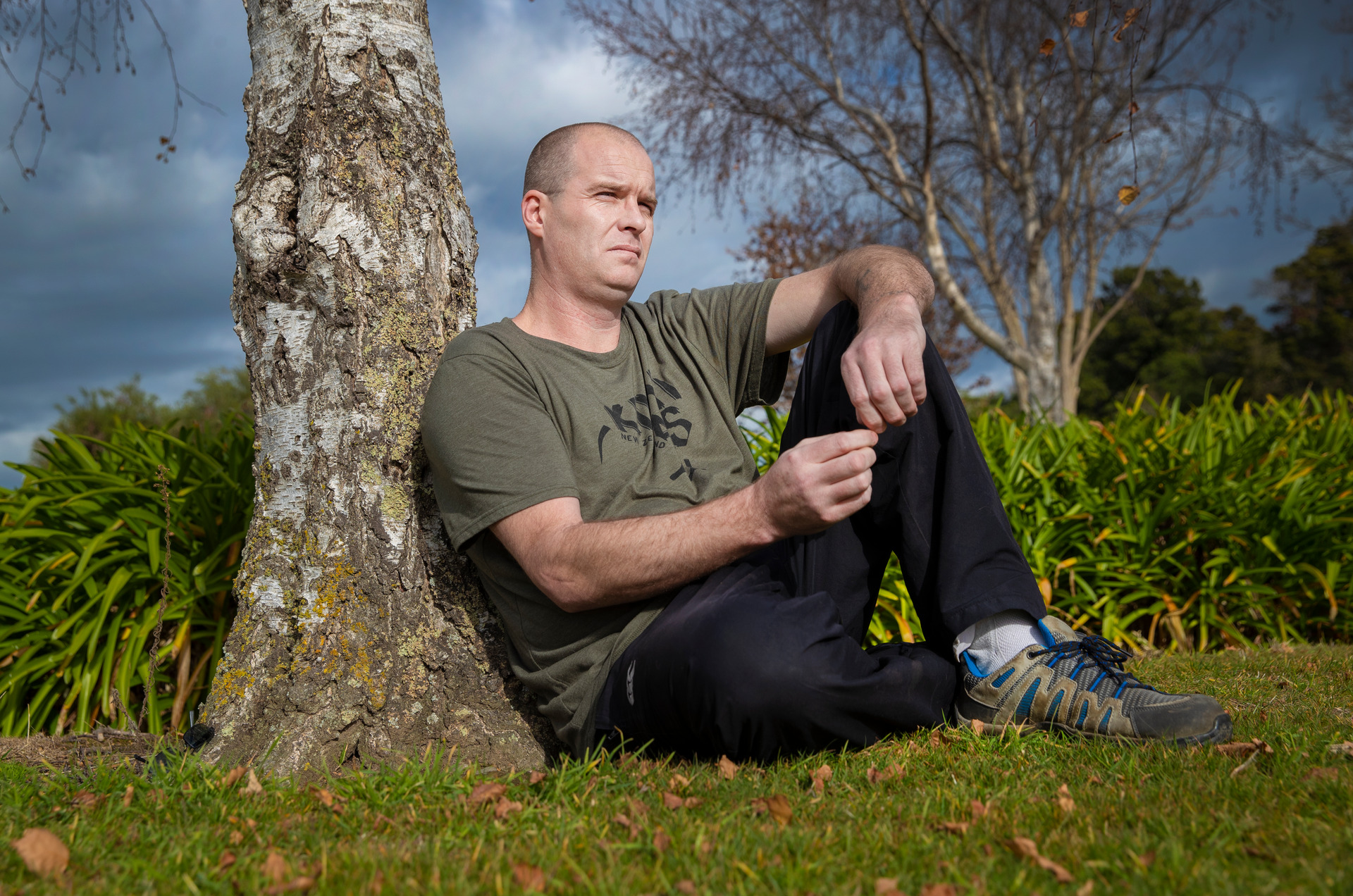 Scott Carr, who spent 3 months at the Whakapakari Youth Trust camp on Great Barrier Island in 1998, sitting in a favourite place at a park near his home in Feilding. Photo / Mark Mitchell