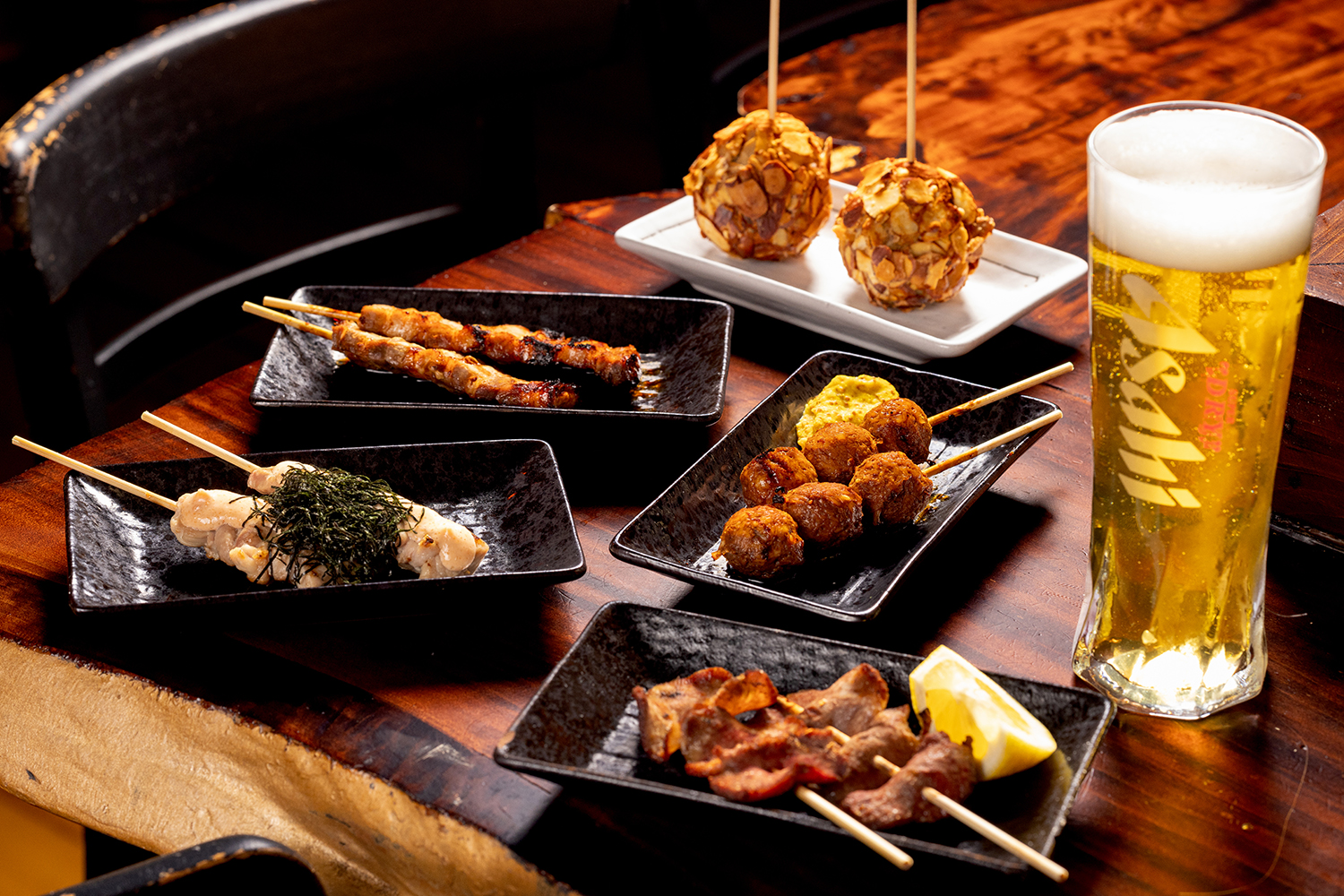 Pork belly, beef tongue and chicken thigh skewers; chicken mince balls and the kūmara and almond balls. Photo / Babiche Martens