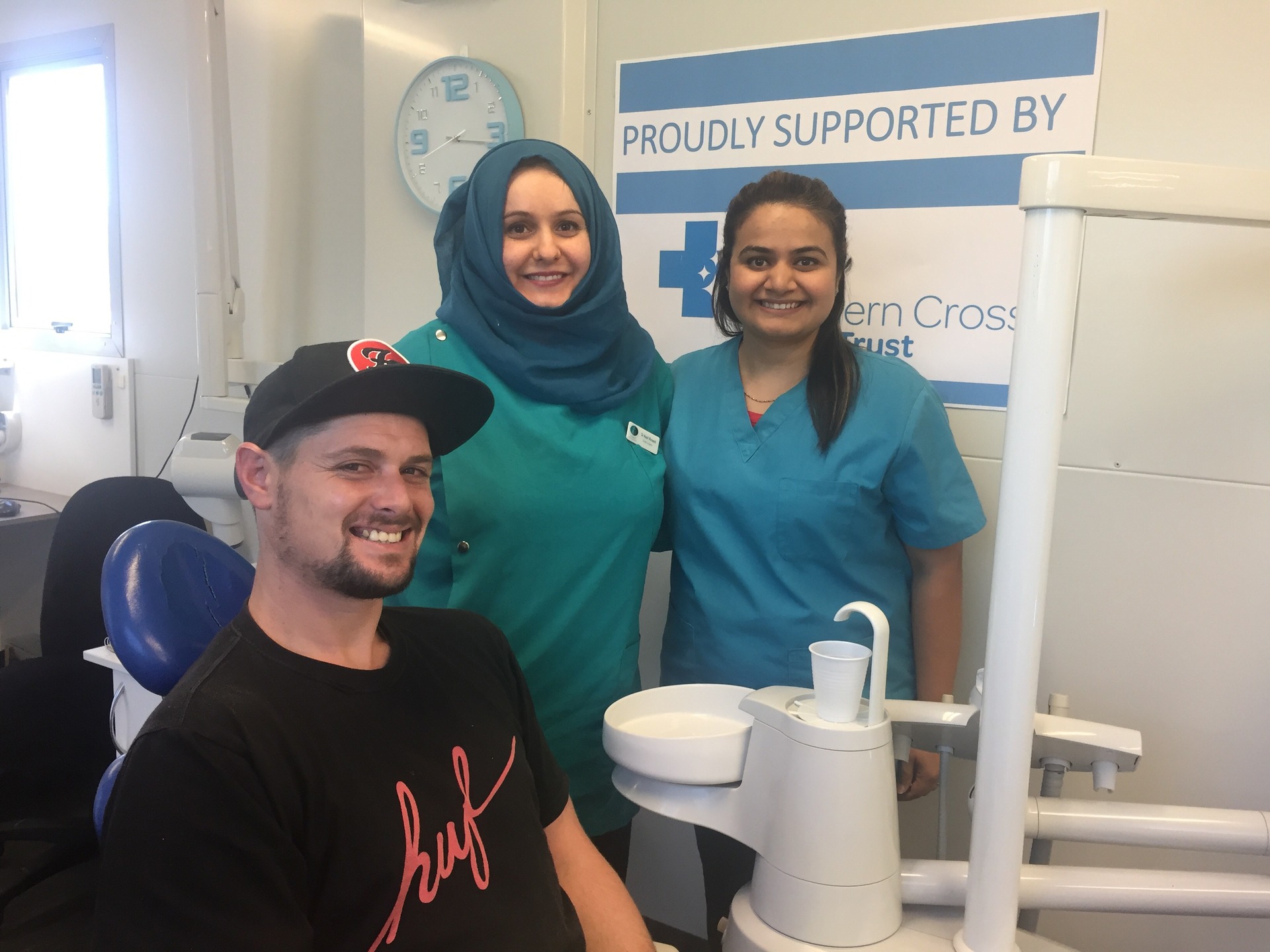 Haydn Colquhoun received free treatment from Revive a Smile, founded by Dr Assil Russell (centre). Photo / supplied