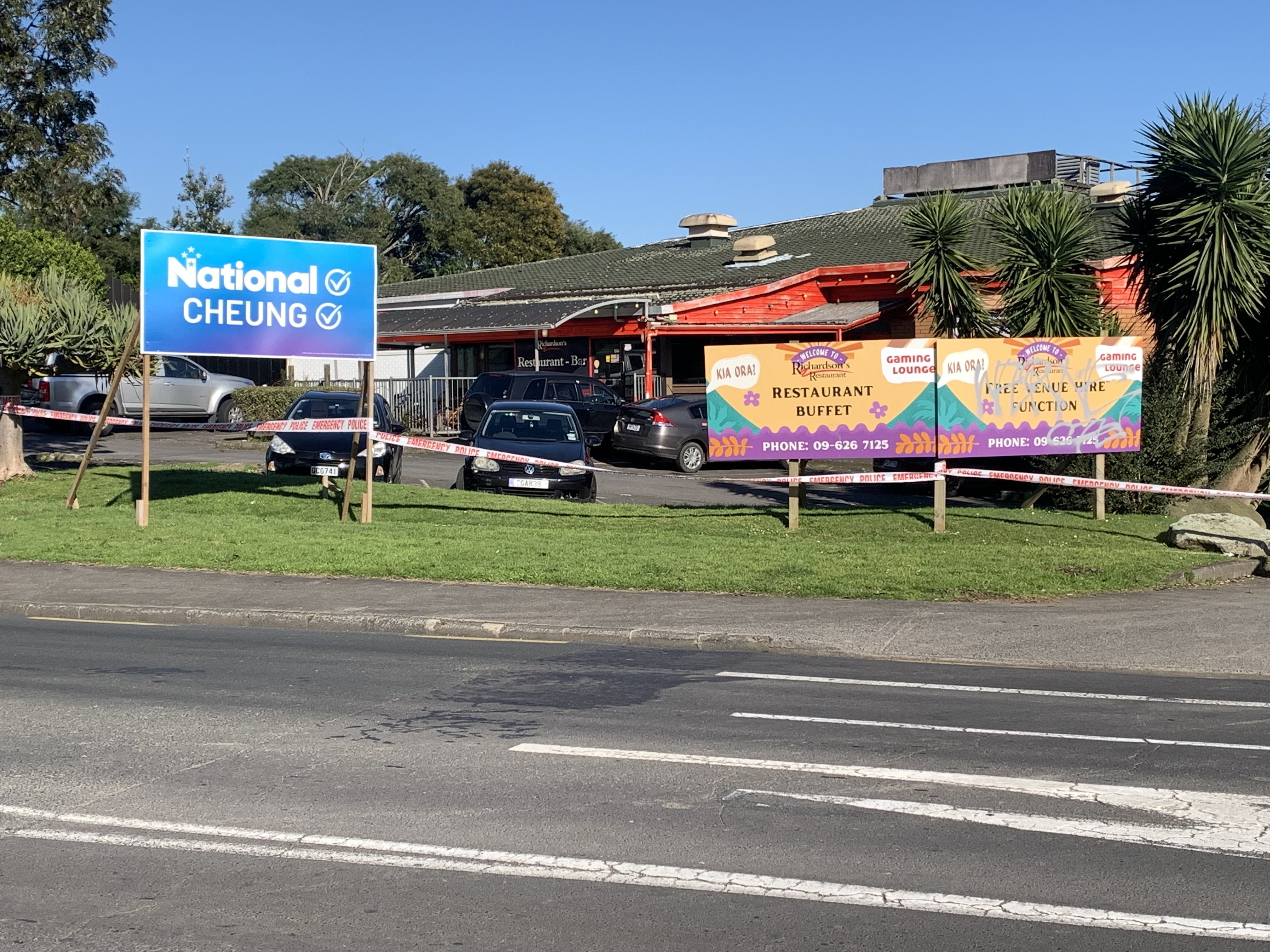 A hoarding for the successful National candidate Carlos Cheung outside a restaurant in Mt Roskill that was the scene of a homicide in September. Photo / Kane Dickie
