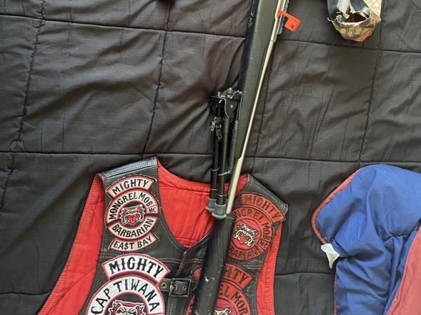A rifles and gang patches seized in the police raids. Source / NZ Police