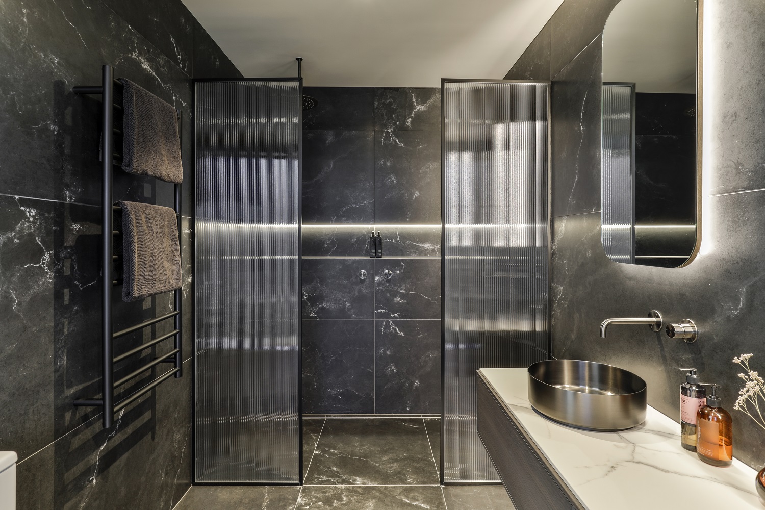 Recessed niches blend function and looks, but if you plan to install one, it’s essential to measure your shampoo bottles and ensure the niche is tall enough. Photo / Jamie Cobel