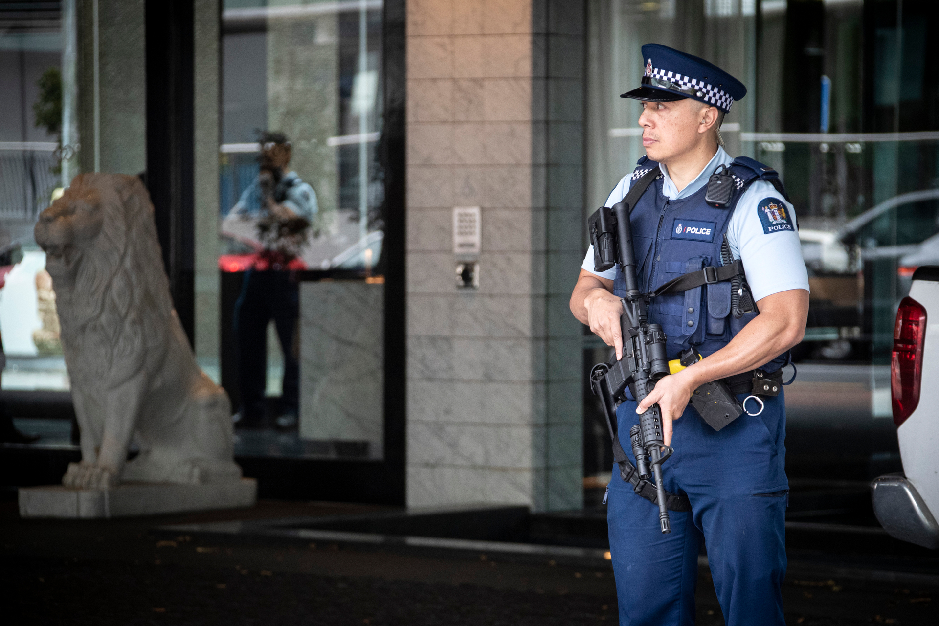 An armed police officer stands guard at the Sofitel on Thursday after the shooting in the CBD linked to a feud between rival gangs the Head Hunters and Mongols. Photo / Jason Oxenham