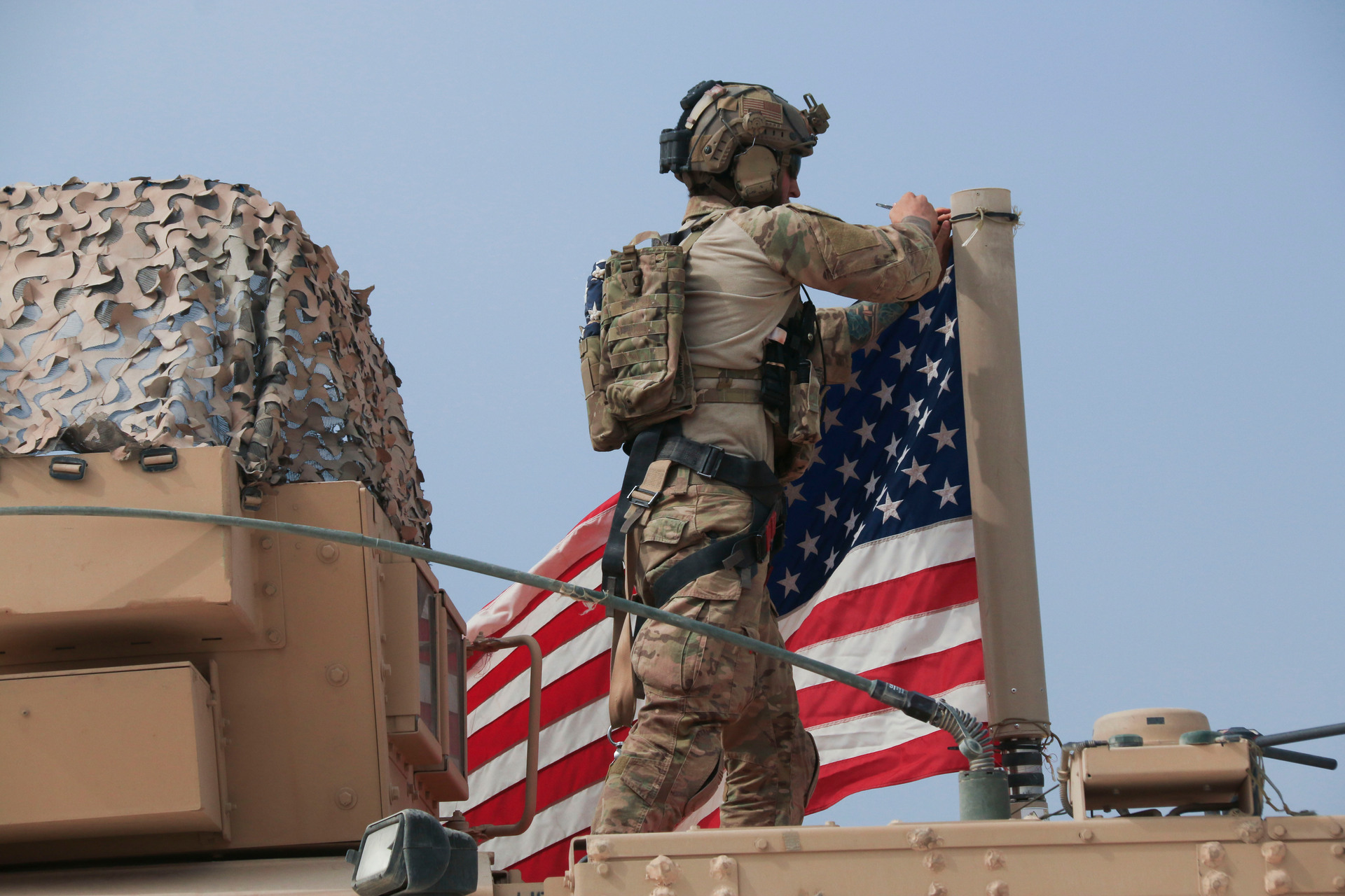 American soldier mount the US flag on a vehicle near the town of Tel Tamr. Photo / AP