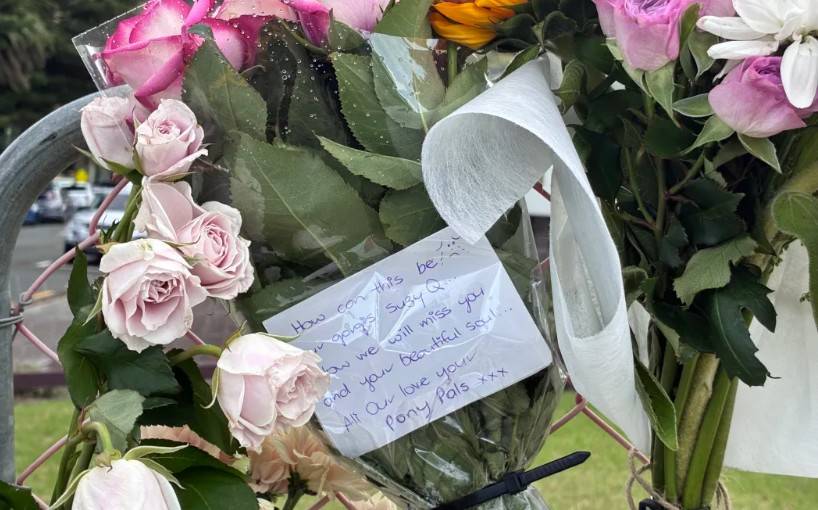 A floral tribute left for Susan Knowles at the Mt Maunganui landslide cordon. Photo / RNZ, Charlotte Cook