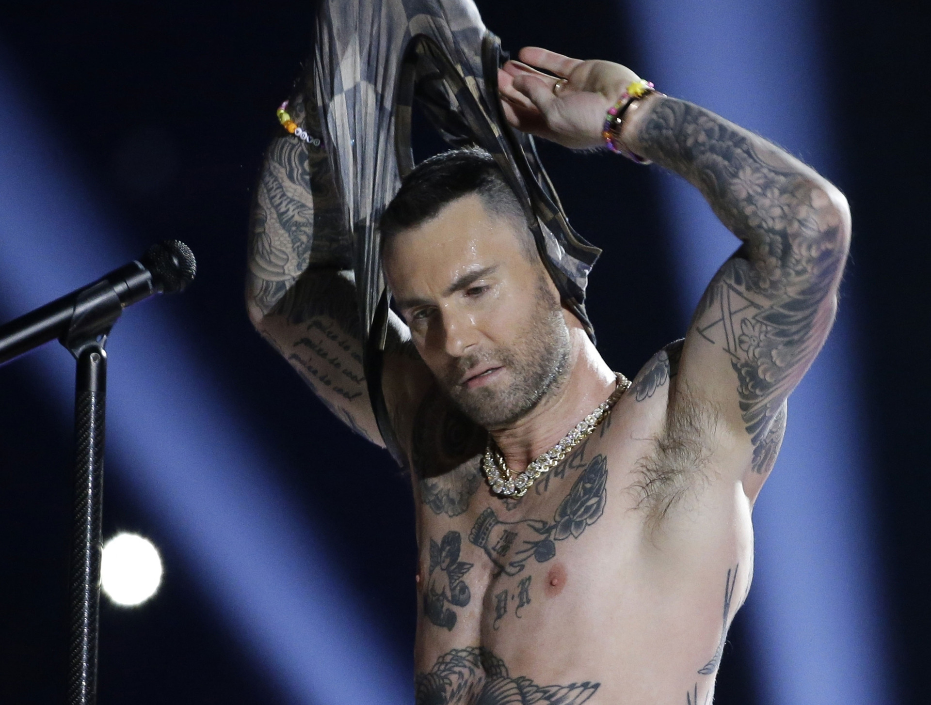 Adam Levine takes his shirt off during the Super Bowl halftime show. Photo / AP