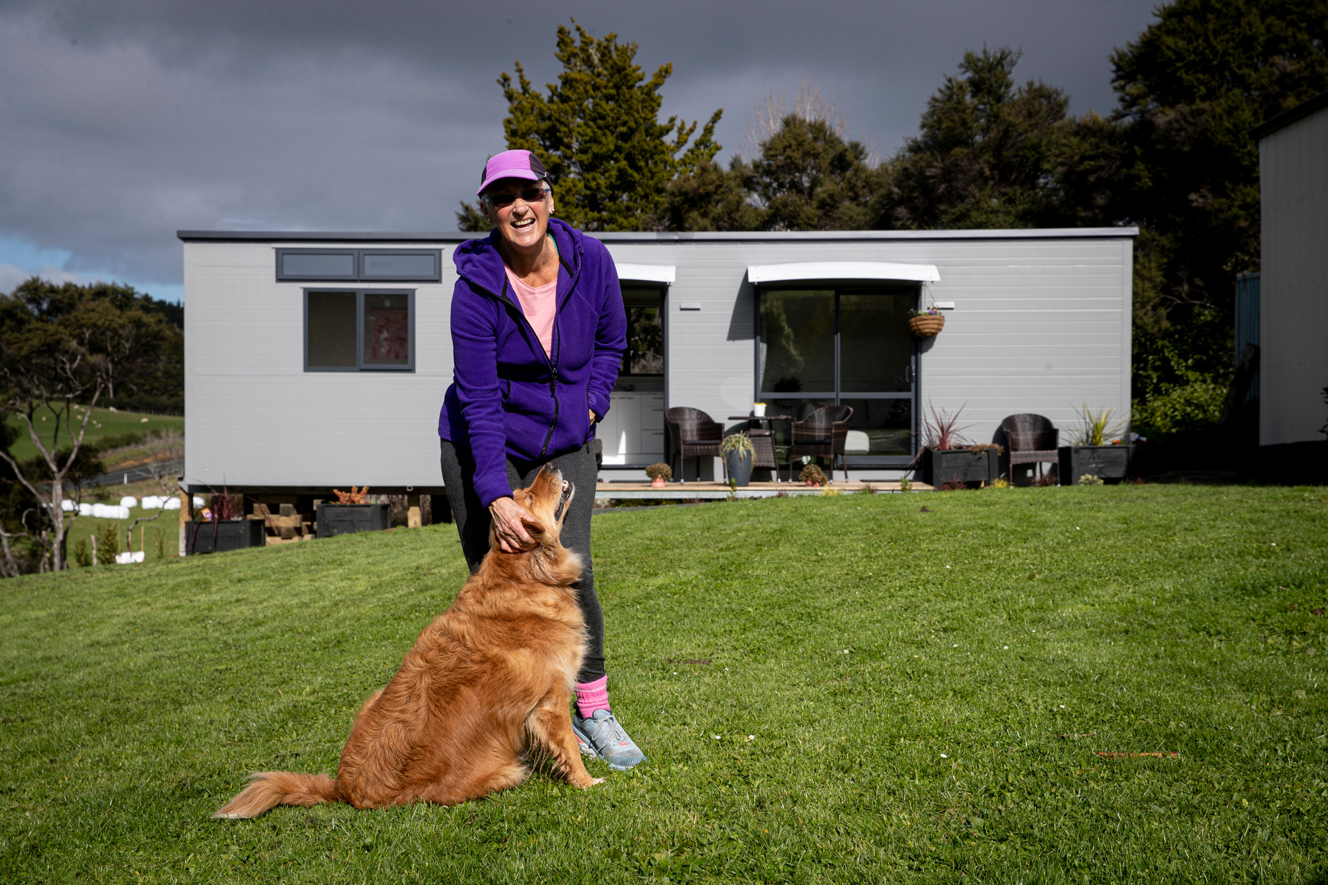 Diane Wood in 2022 with dog Brandy outside her tiny house in Warkworth. Photo / Dean Purcell