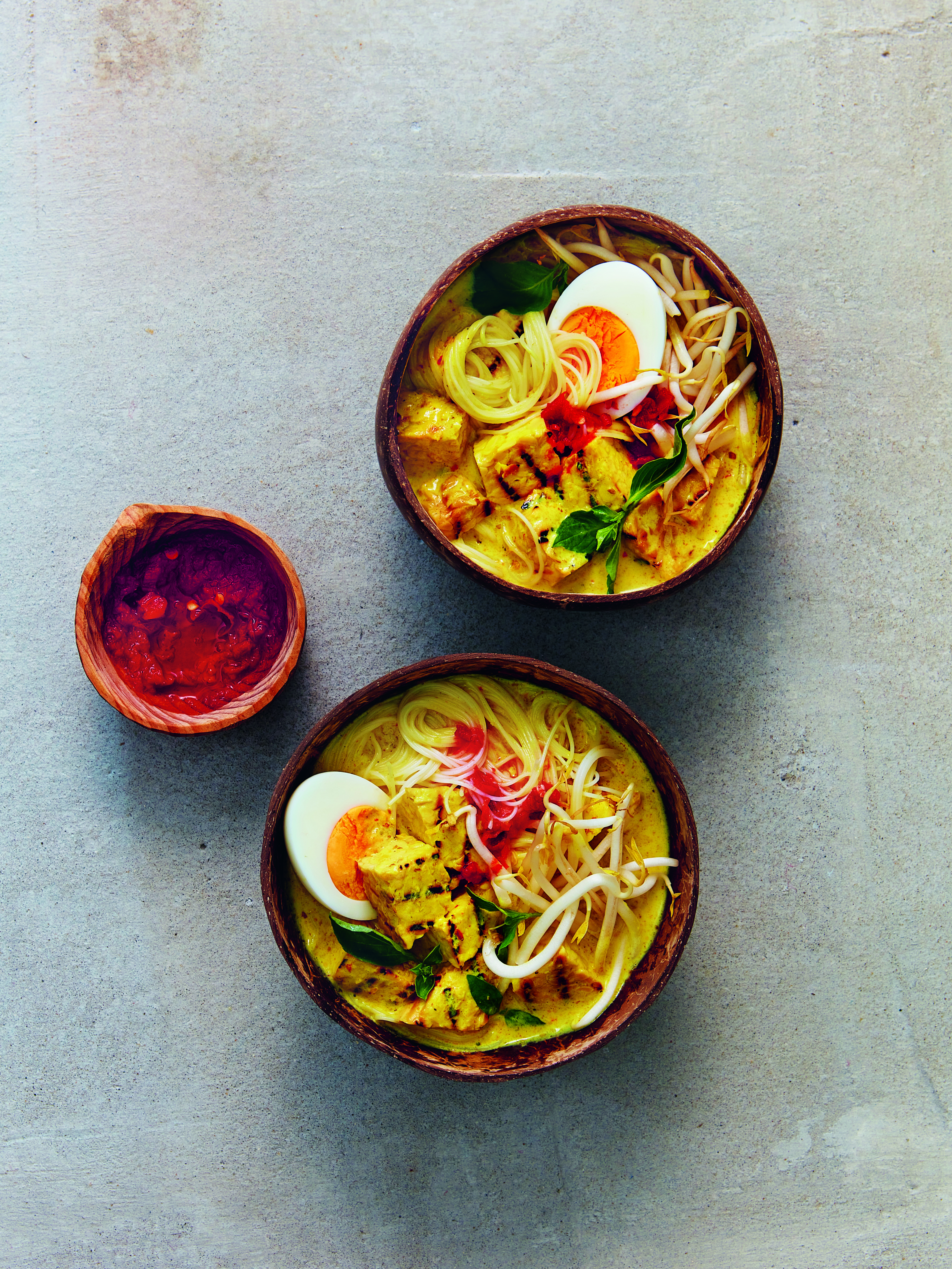 The broth of this laksa golden from turmeric and lemongrass. Photo / Supplied