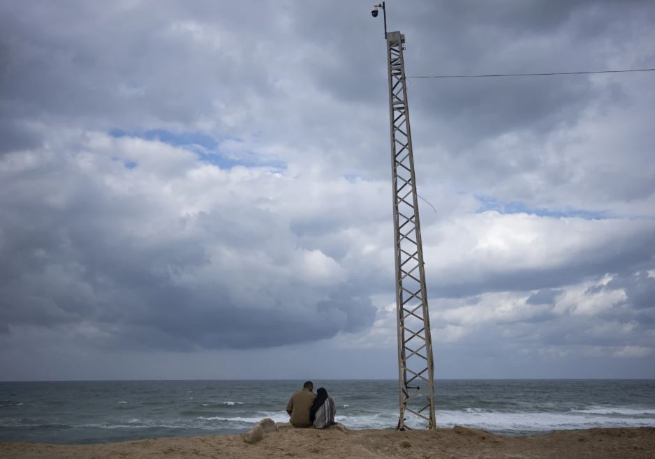 Palestinians displaced by the Israeli air and ground offensive on the Gaza Strip sit on the beach in Rafah on the border with Egypt. Photo / AP