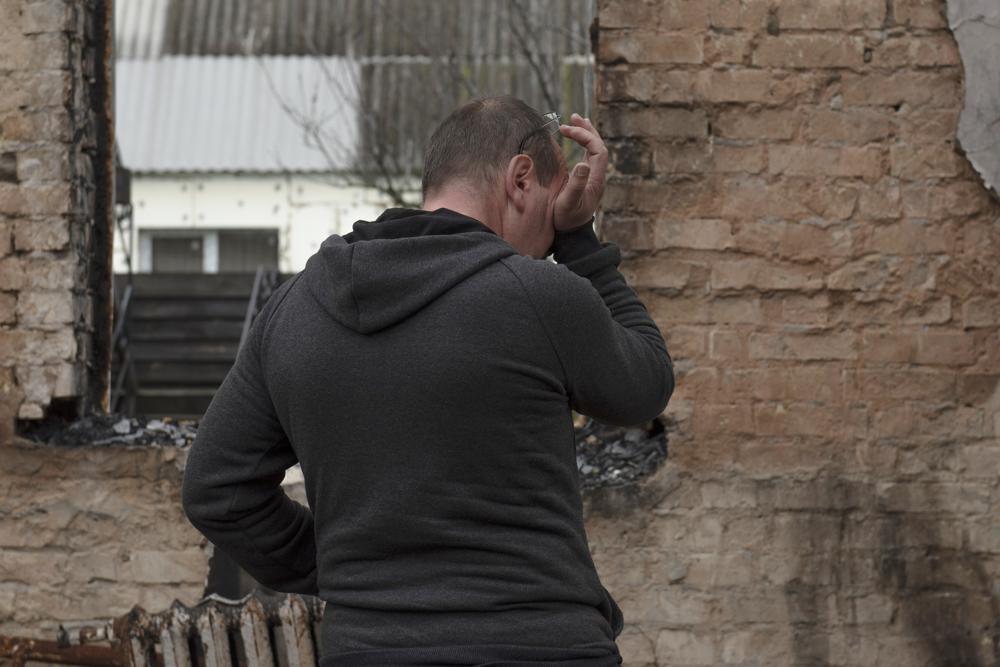 Vadym Zherdetsky reacts standing in the remains of his destroyed house, in the village of Moshun, outside Kyiv, Ukraine. Photo / AP
