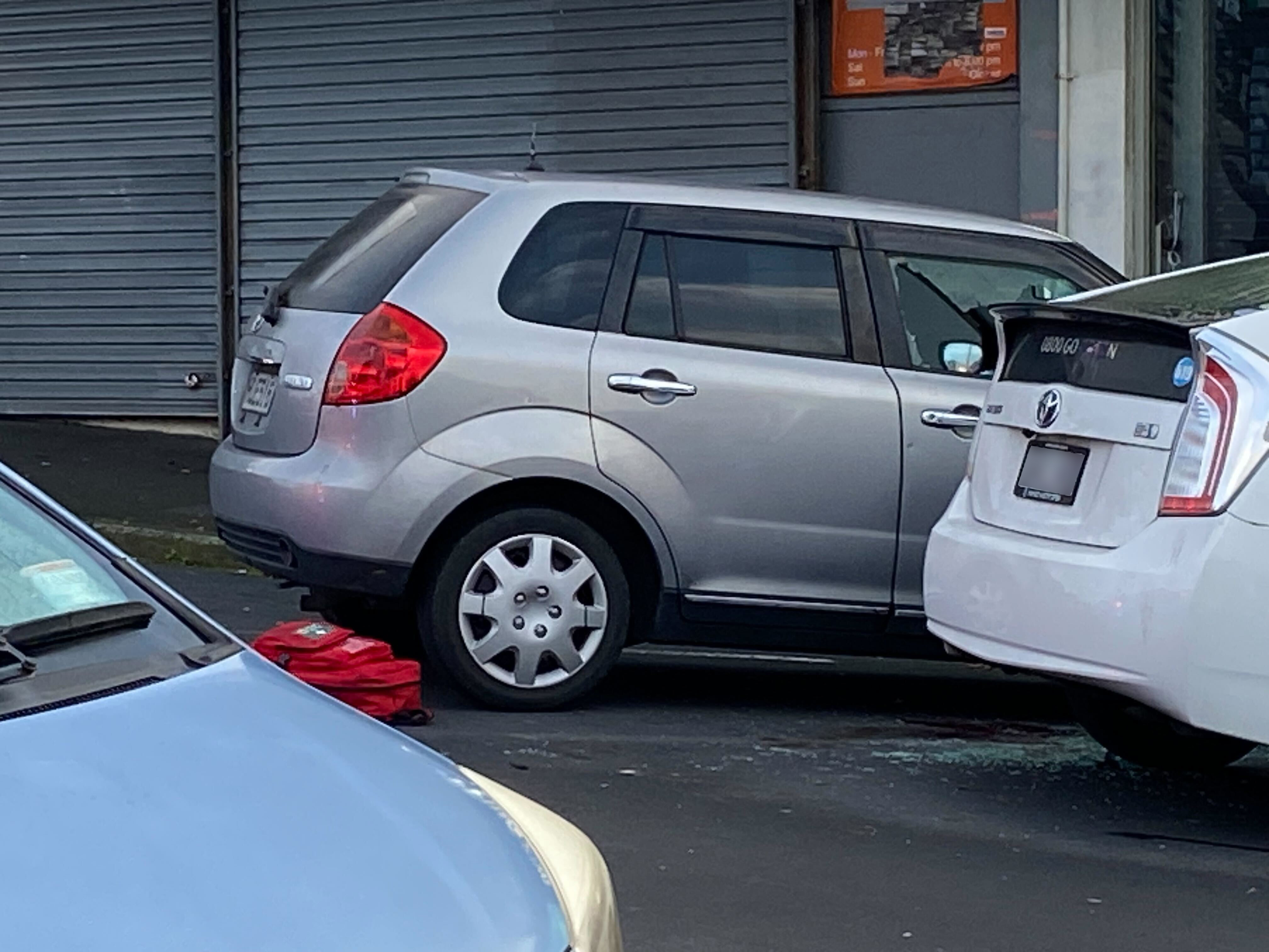 A car with a smashed window at the driver's seat can be seen within the police cordon at the scene of a homicide in Auckland's Mt Wellington overnight. Photo / Isaac Davison