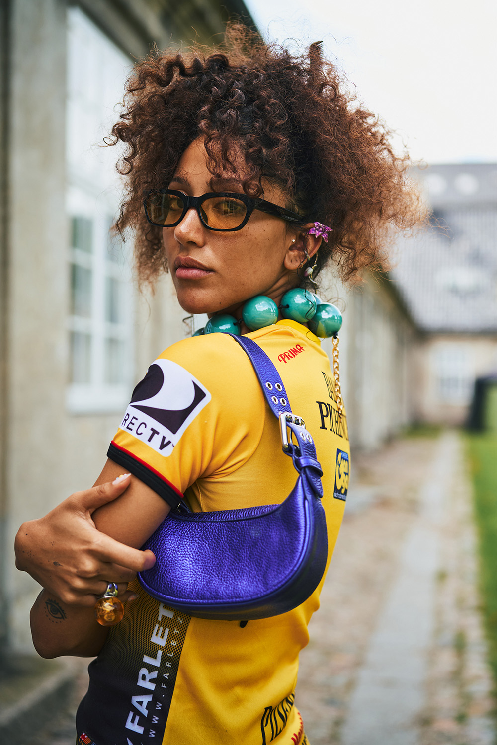 A jersey is styled with tinted sunglasses and a small shoulder bag. Photo / Simbarashe for The New York Times
