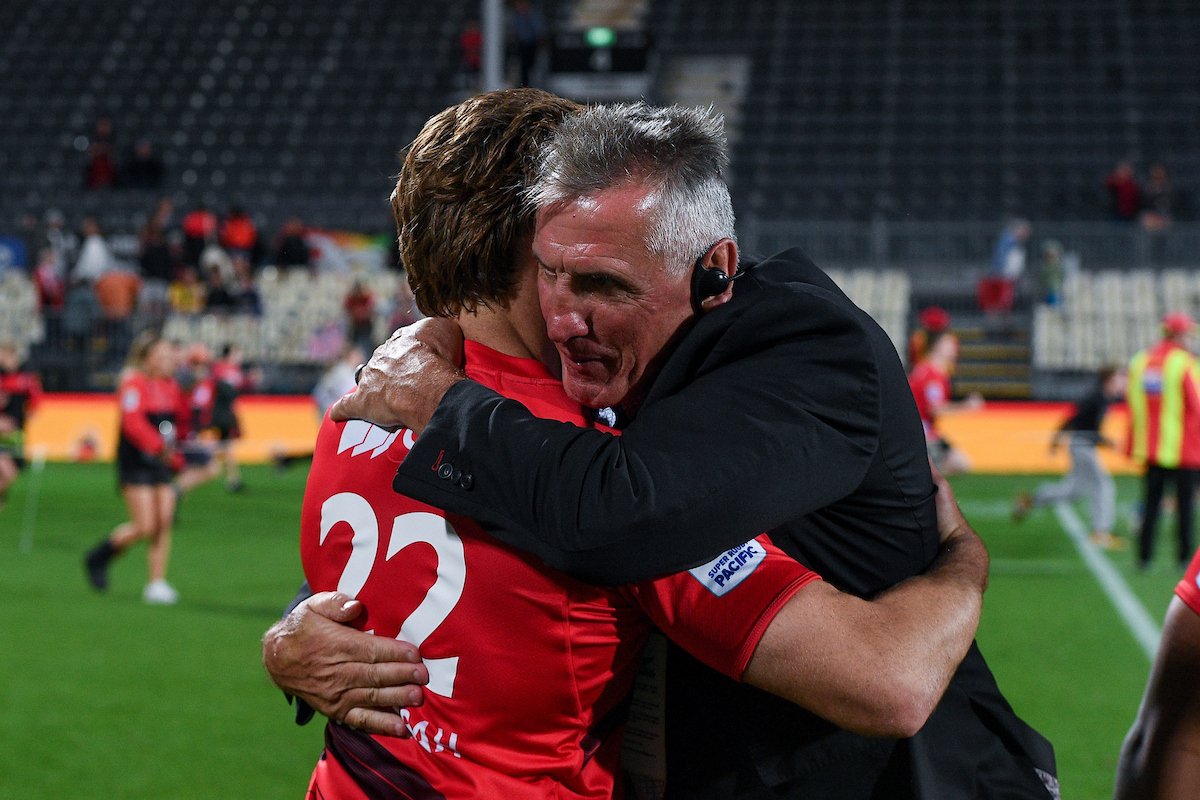 Rob Penney embraces James O'Connor after defeating the Hurricanes. Photo / Photosport