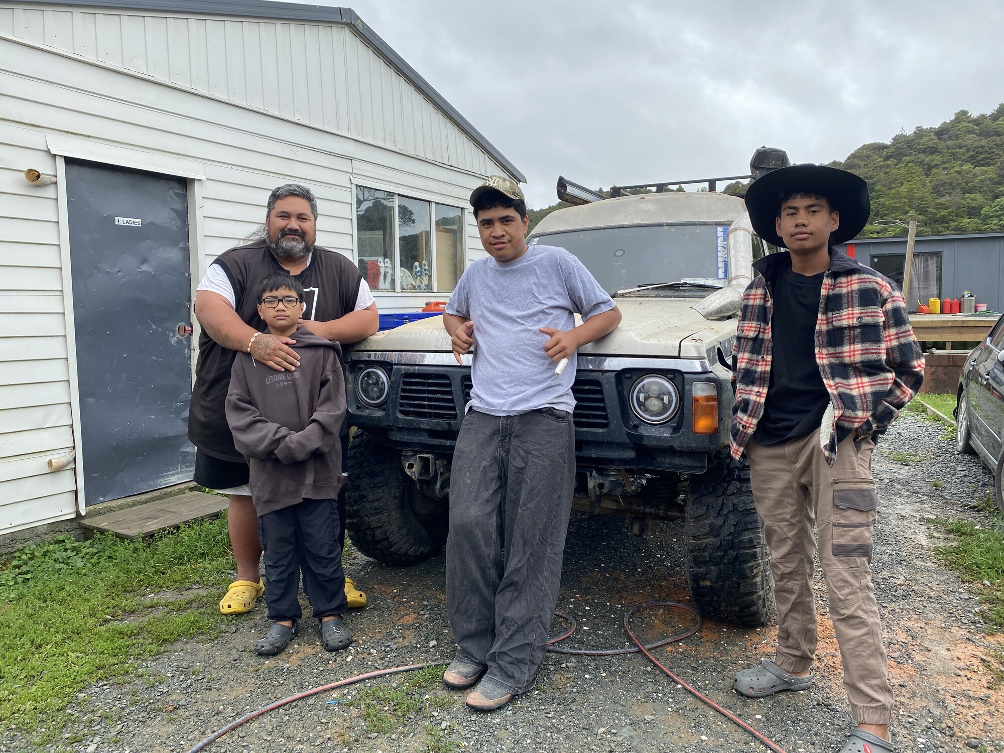 Mokau’s Tai Iorangi (back left), with sons Louis, Jeziah and Hingtoi, helped clear the roads on Sunday morning. 
Photo / Denise Piper