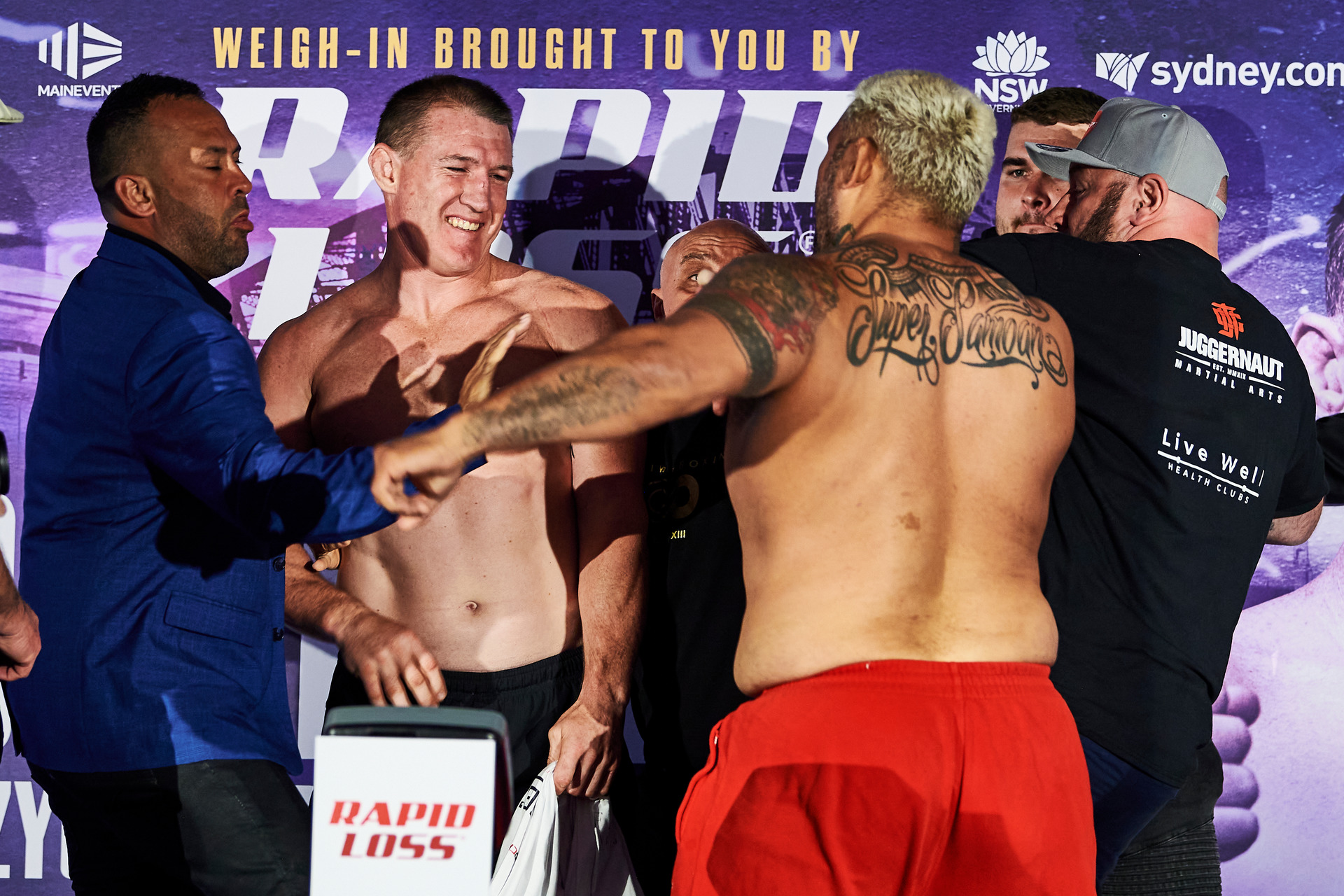 Boxing Kiwi UFC fighter Mark Hunt throws punch at Australian league legend Paul Gallen during weigh-in for blockbuster fight